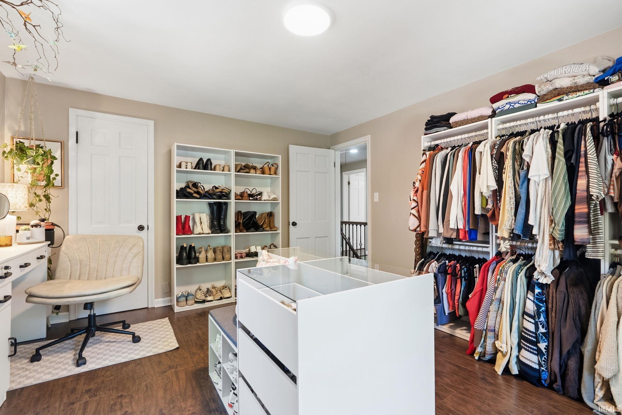 Built-in custom closet system featuring multiple hanging rods and shelving