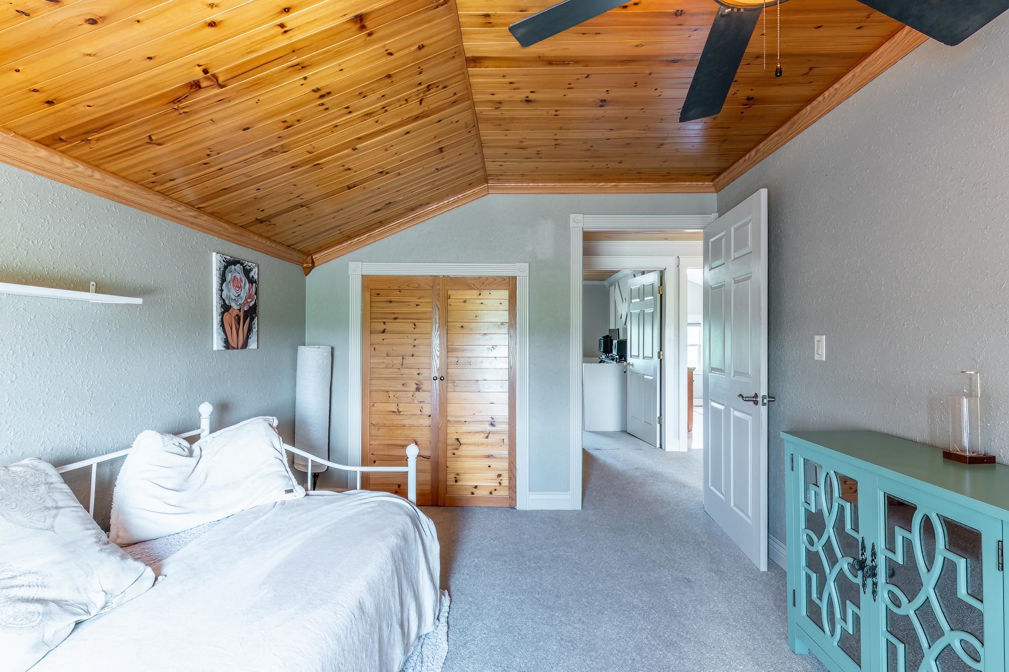 Vaulted wood-paneled ceiling with exposed beams