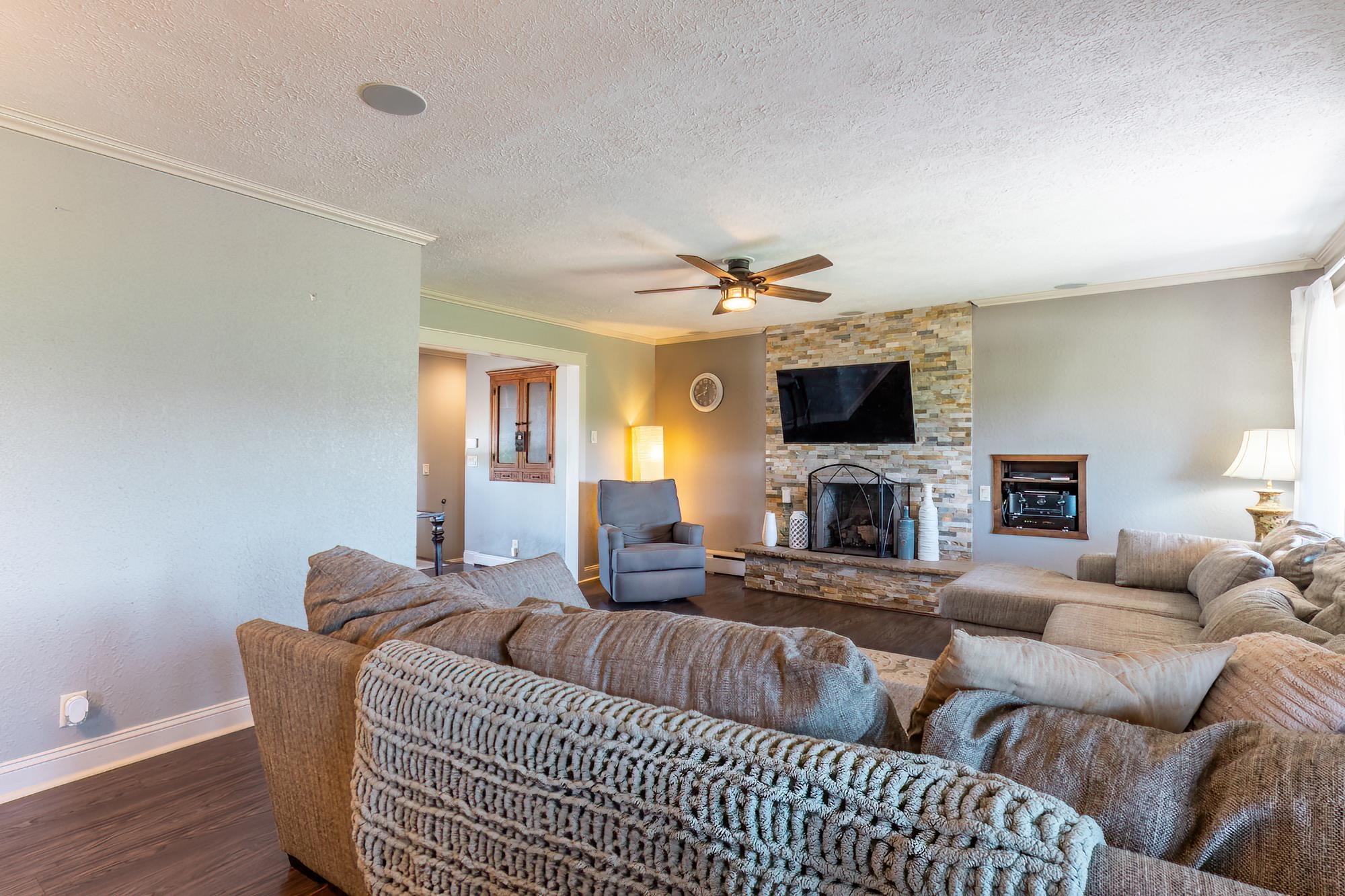 Living area featuring a stone-clad fireplace and hearth