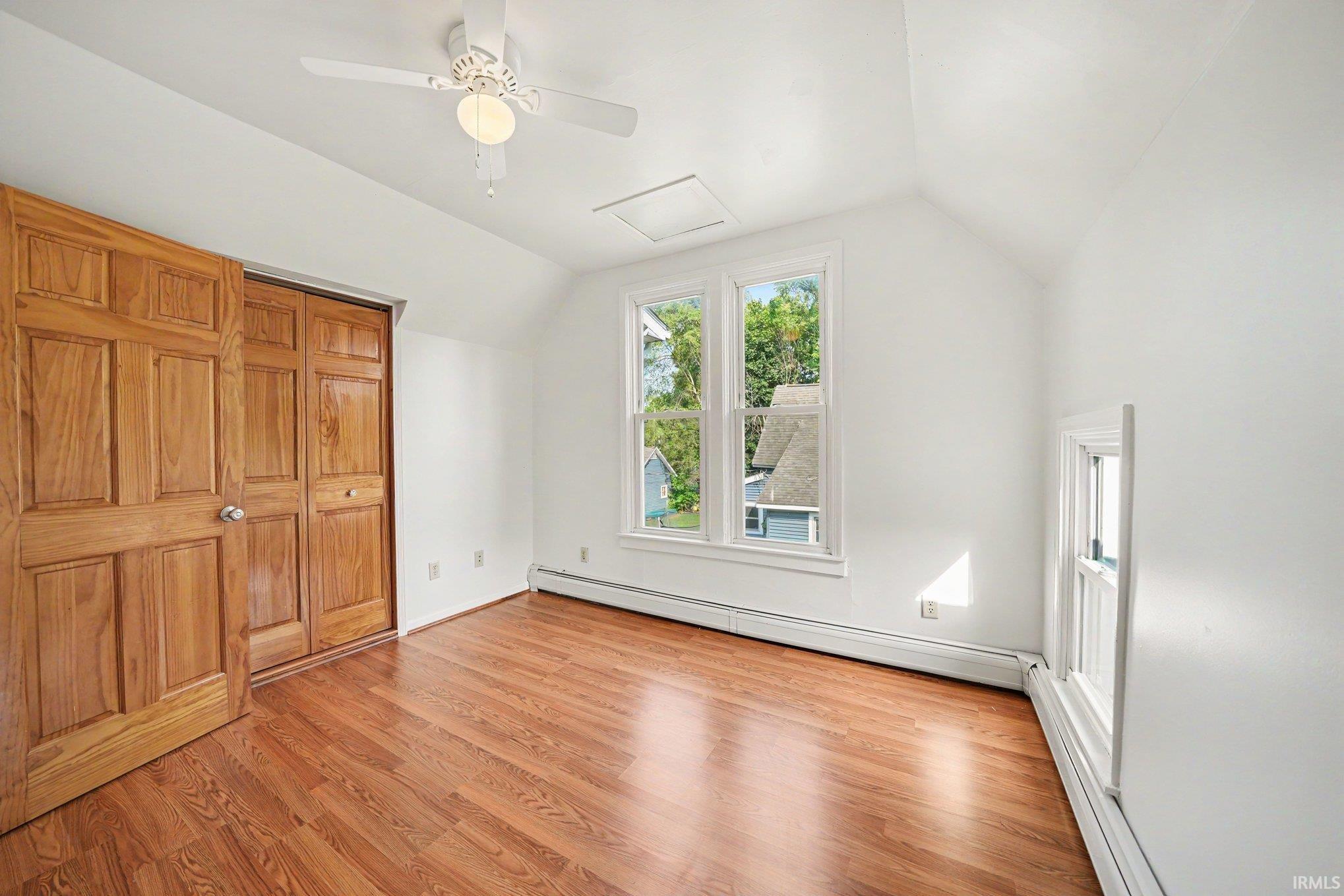 Room featuring wood-finish flooring and bright white walls