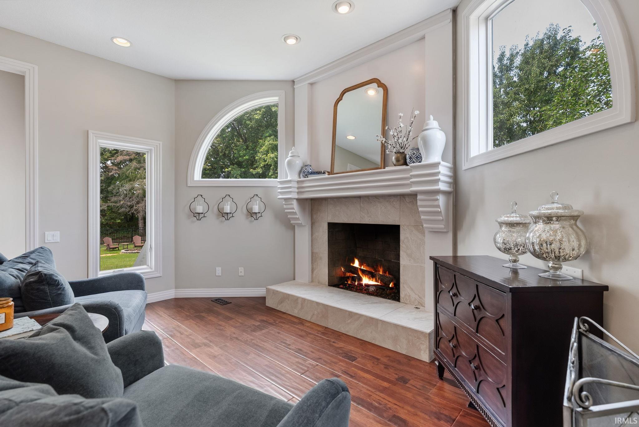Fireplace with a stone surround and ornate mantel