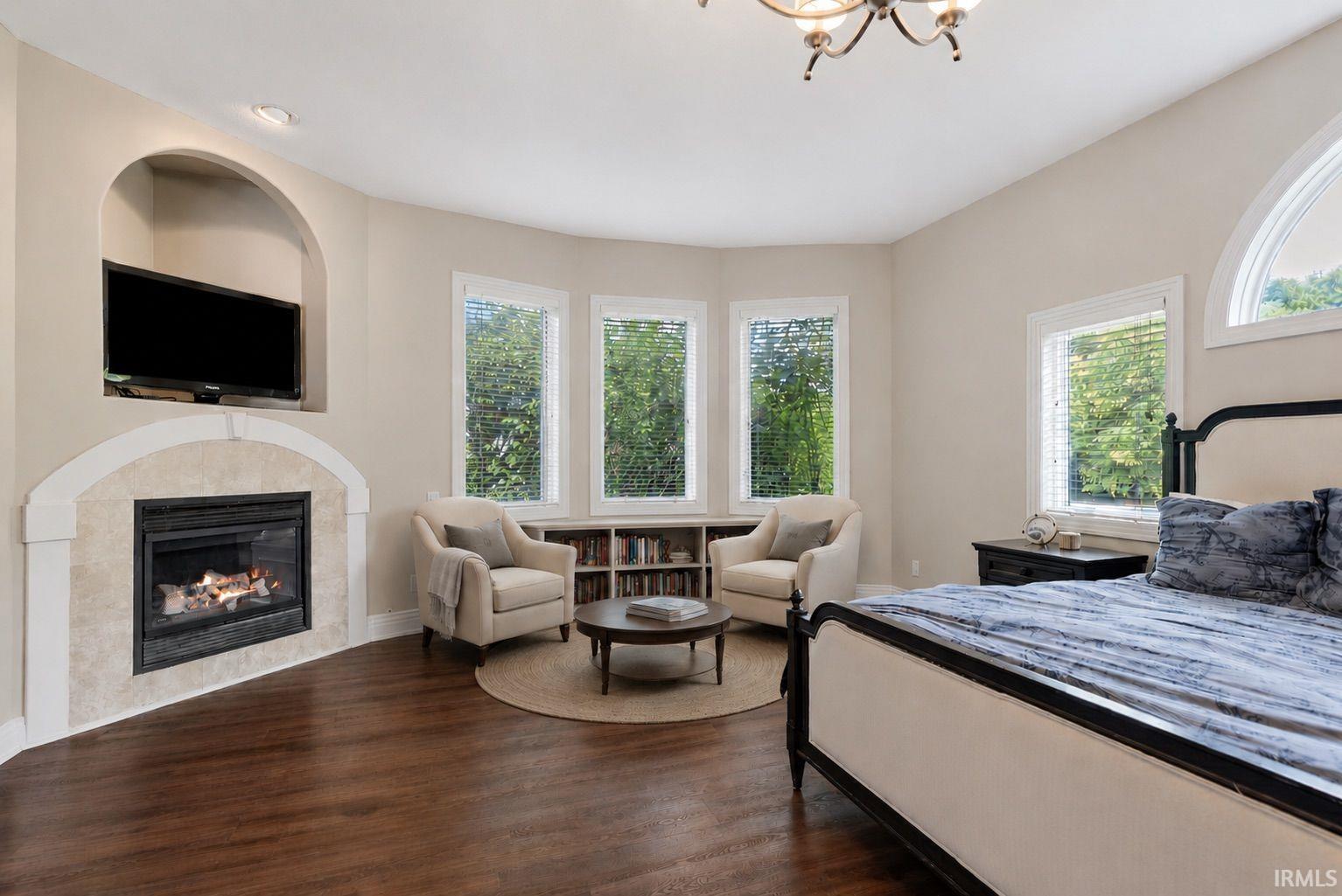 Spacious room with rich wood-finish flooring