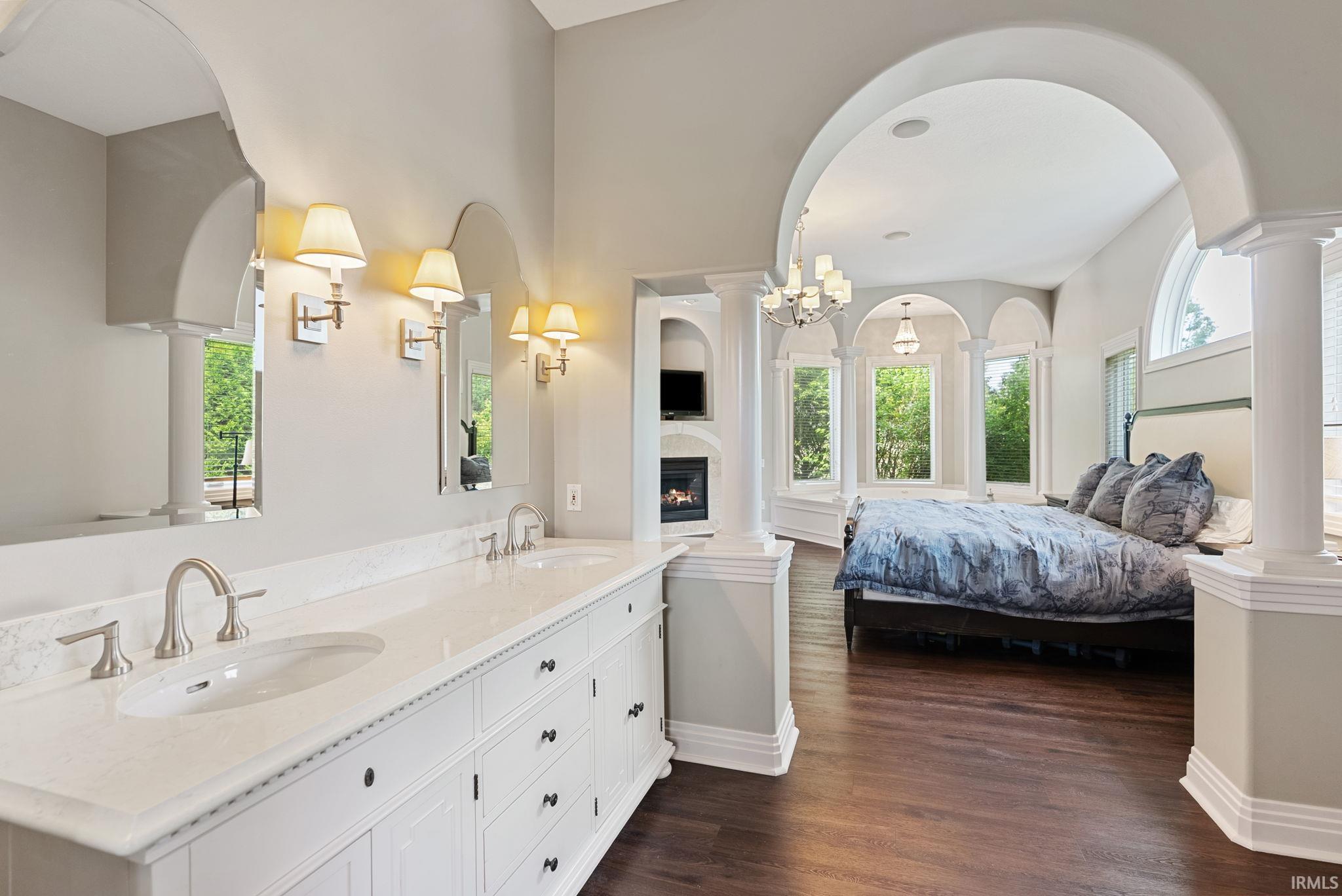 Dual-sink vanity with a light countertop, white cabinetry, and brushed nickel fixtures