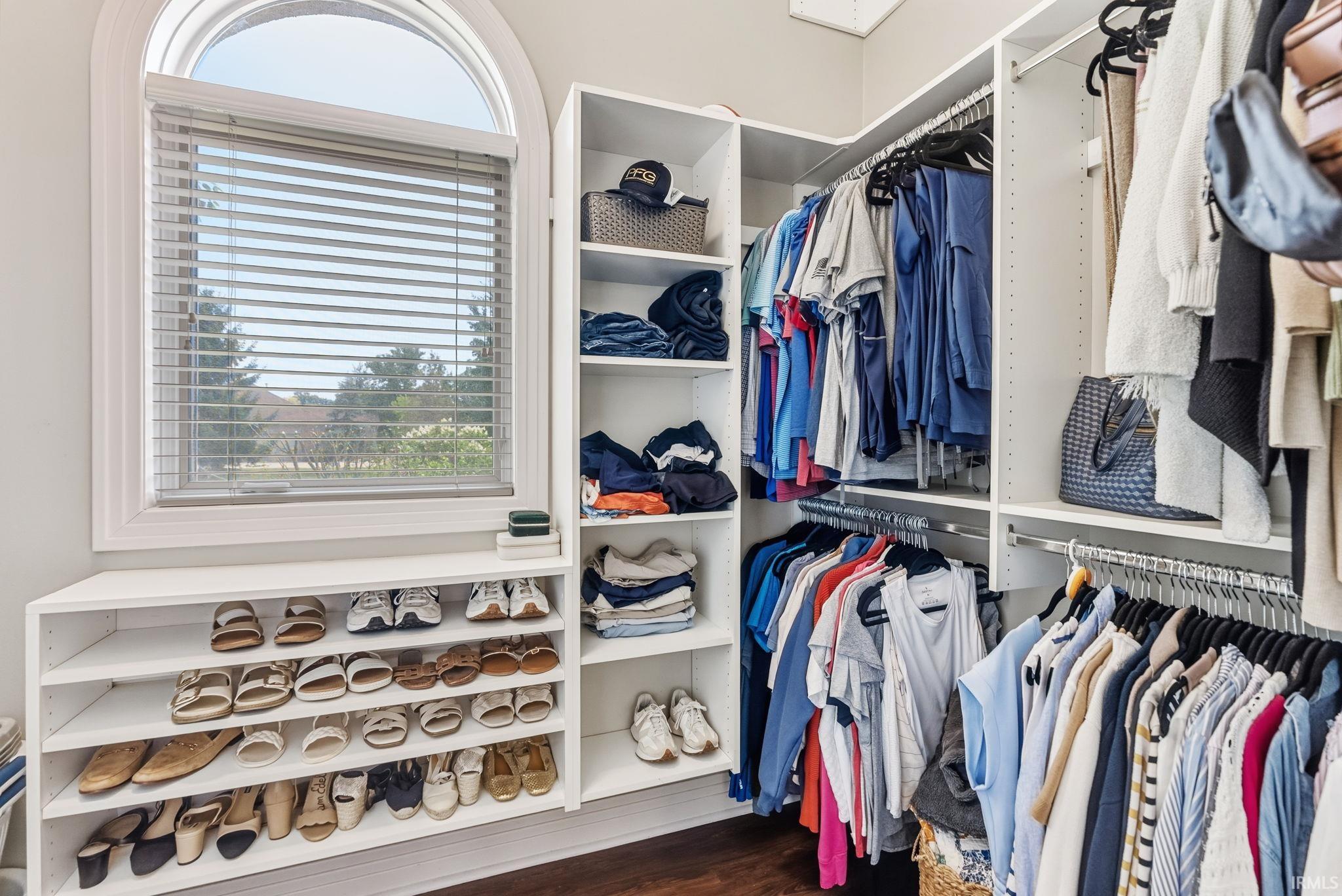 Custom closet system featuring extensive shelving and hanging space