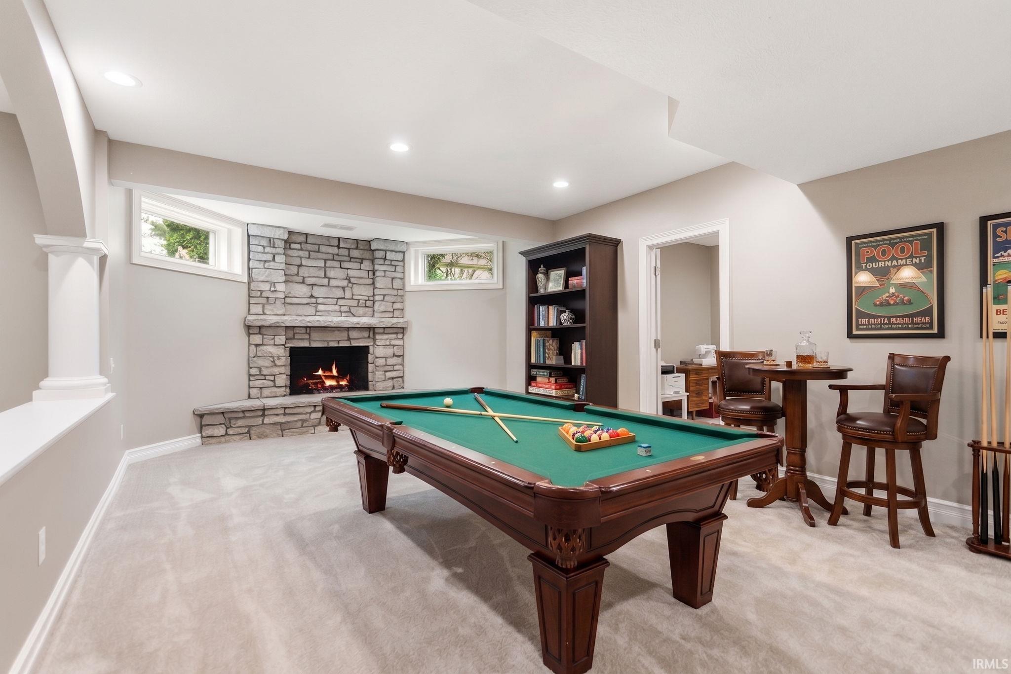 Spacious recreation area featuring light-toned carpeting and recessed lighting