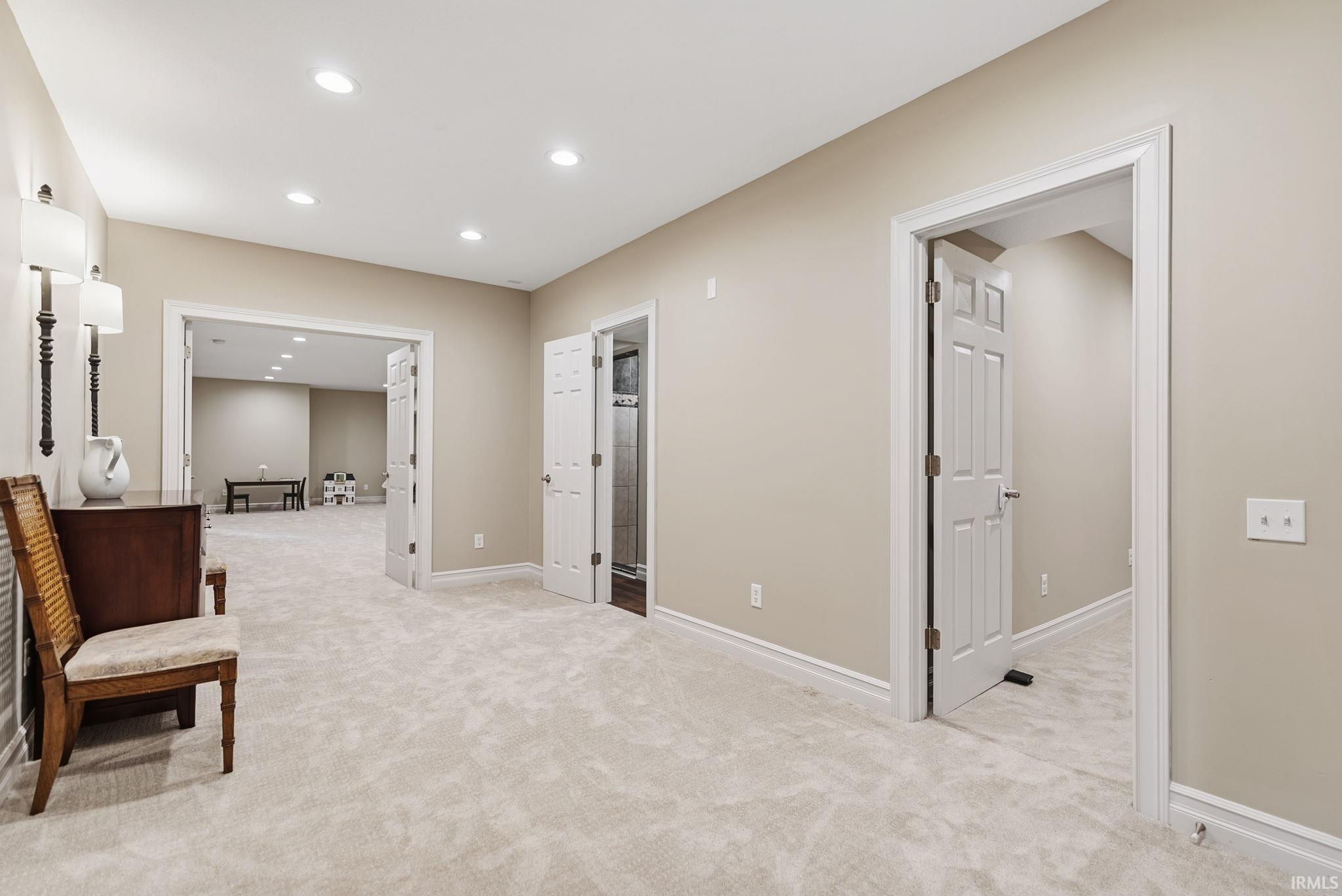 Spacious carpeted area featuring recessed lighting, light neutral wall paint, and white trim