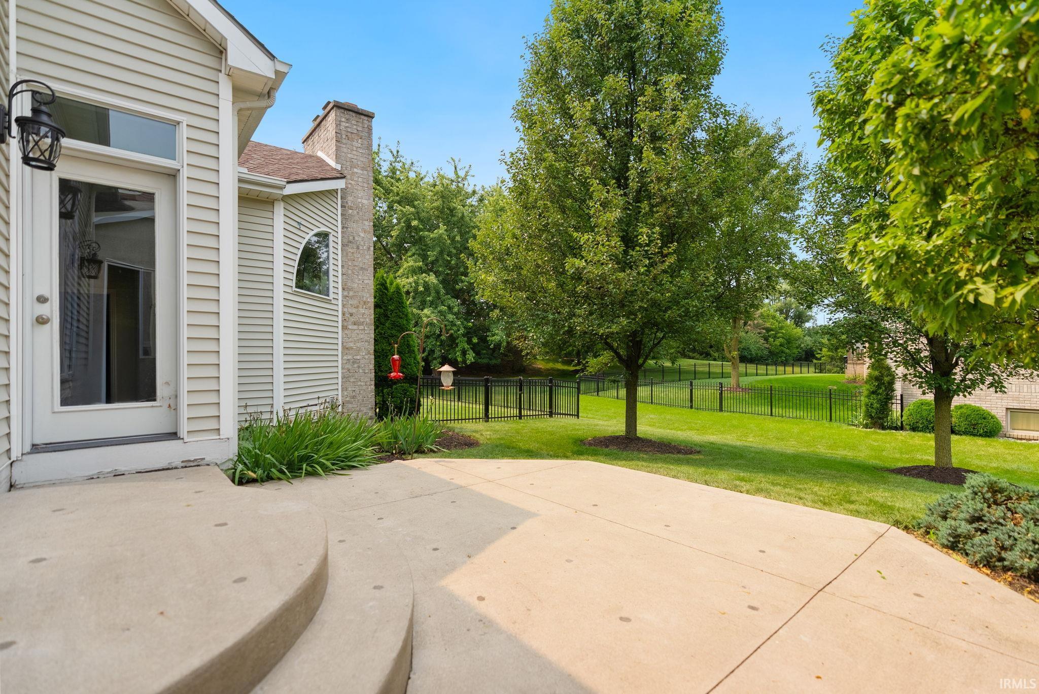 Expansive concrete patio with curved steps