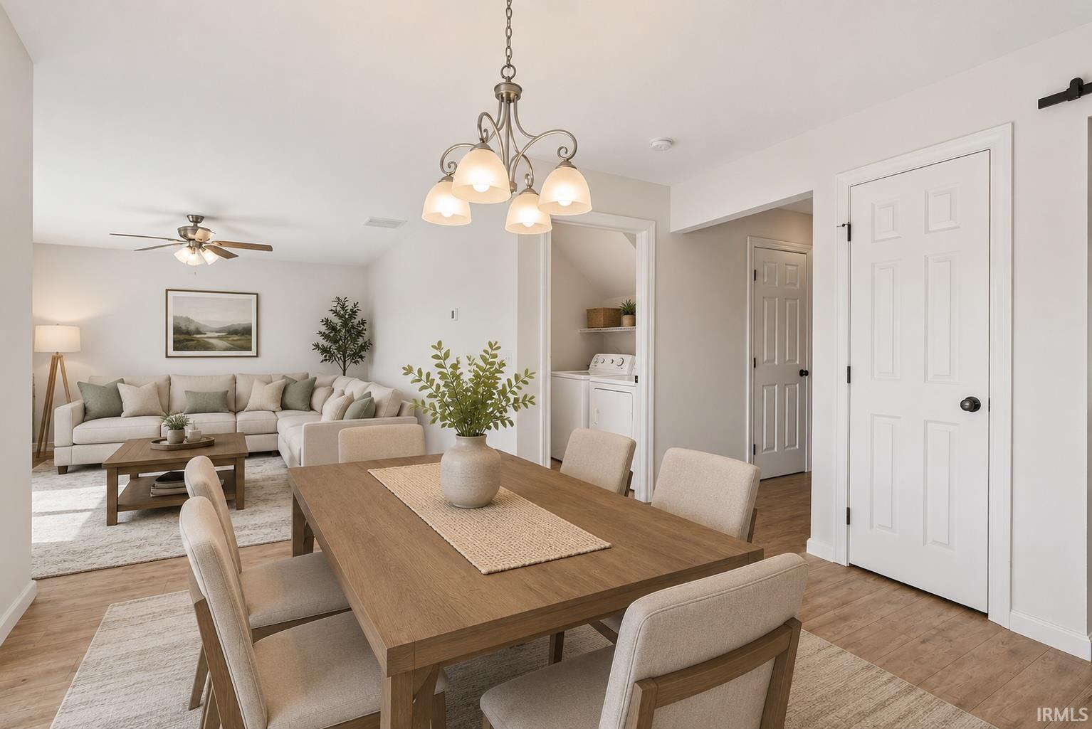 Dining area featuring a wooden table with seating for four, pendant lighting, and wood-finish flooring