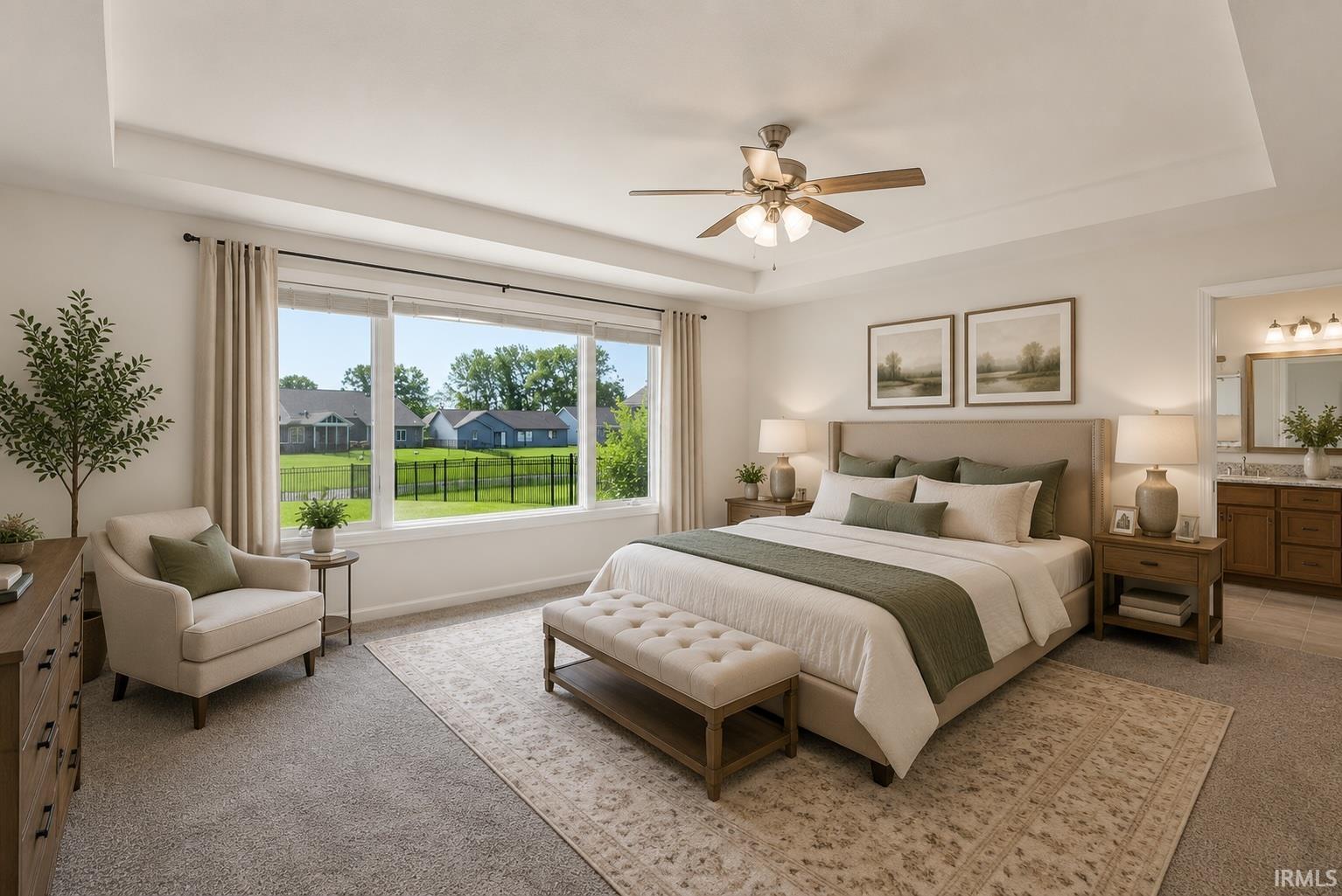 Bedroom featuring a wide window with outdoor scenery, tray ceiling, ceiling fan, and carpeted flooring