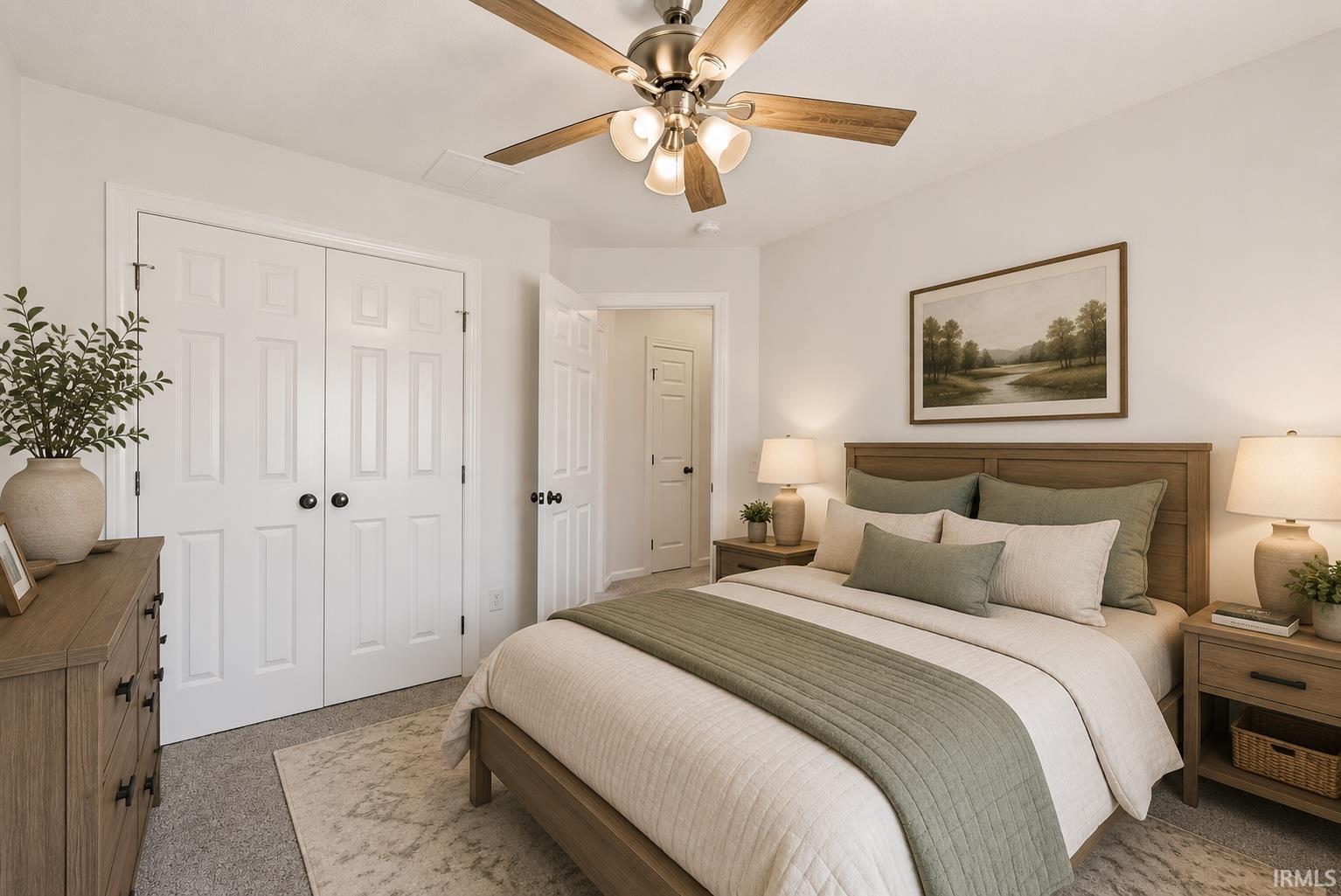 Carpeted room featuring a ceiling fan with light kit, panel doors, and neutral wall paint