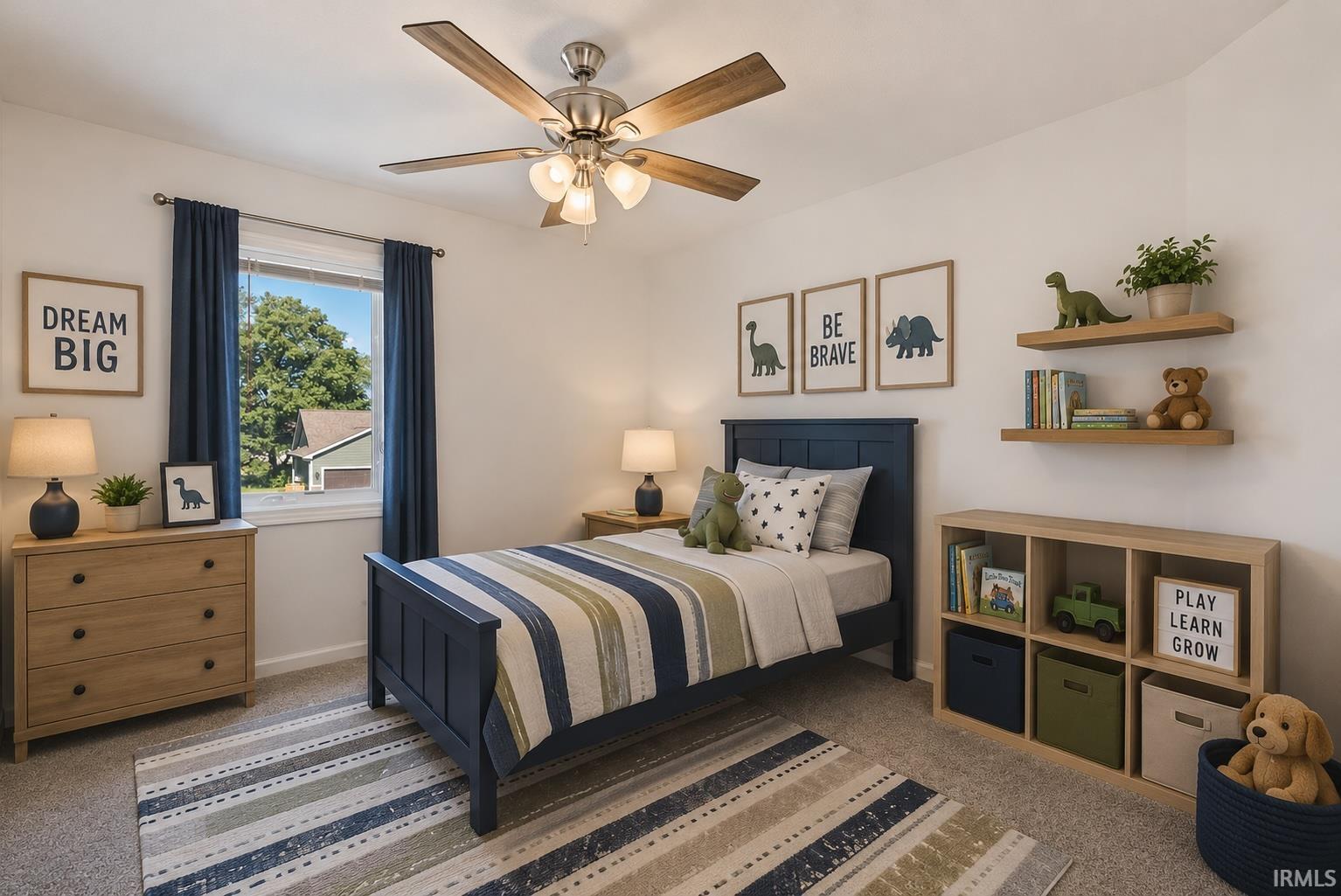 Carpeted bedroom featuring a ceiling fan with light fixture, large window, natural wood-finish dresser, and wood-finish open shelving