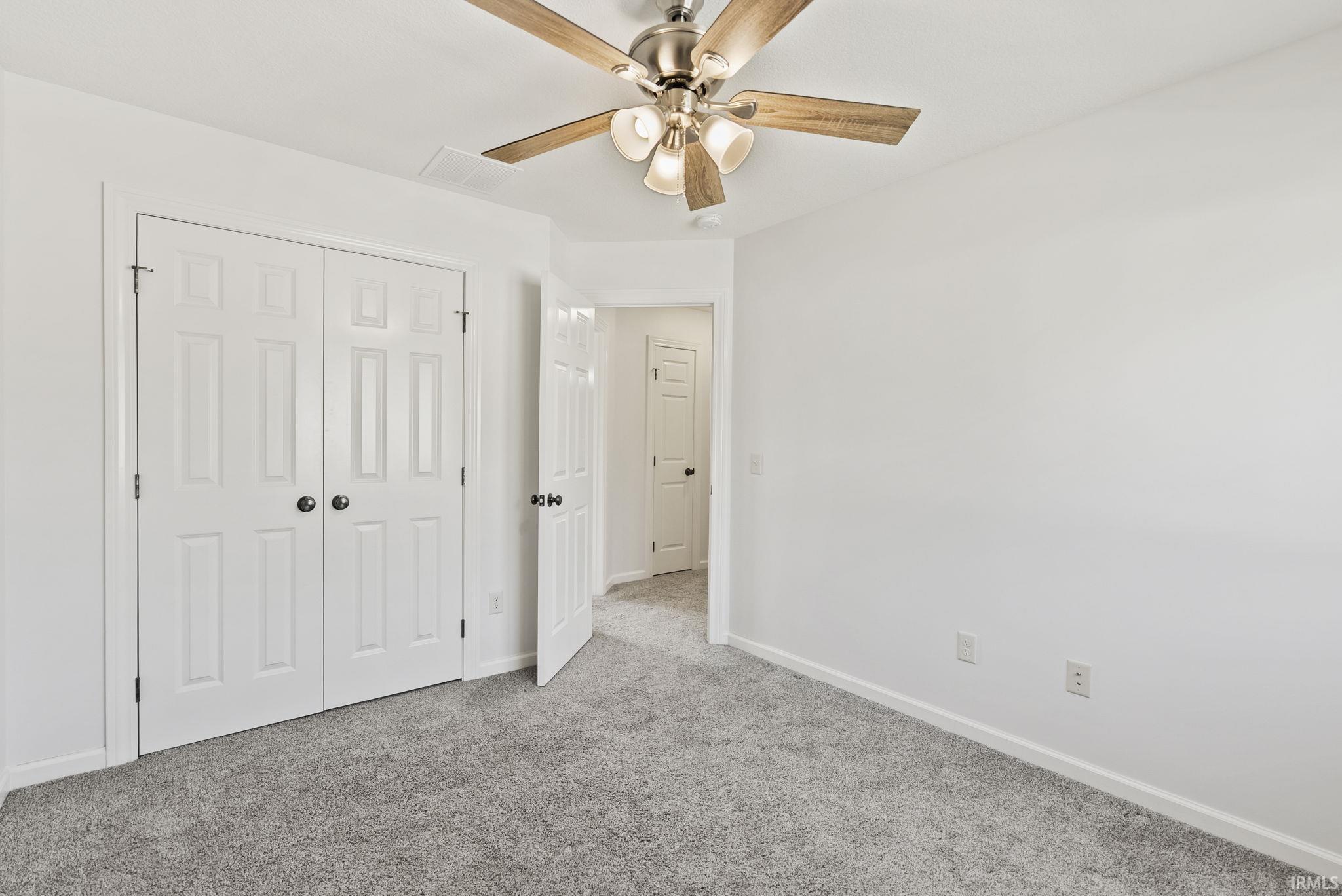 Neutral white walls framing gray textured carpeting
