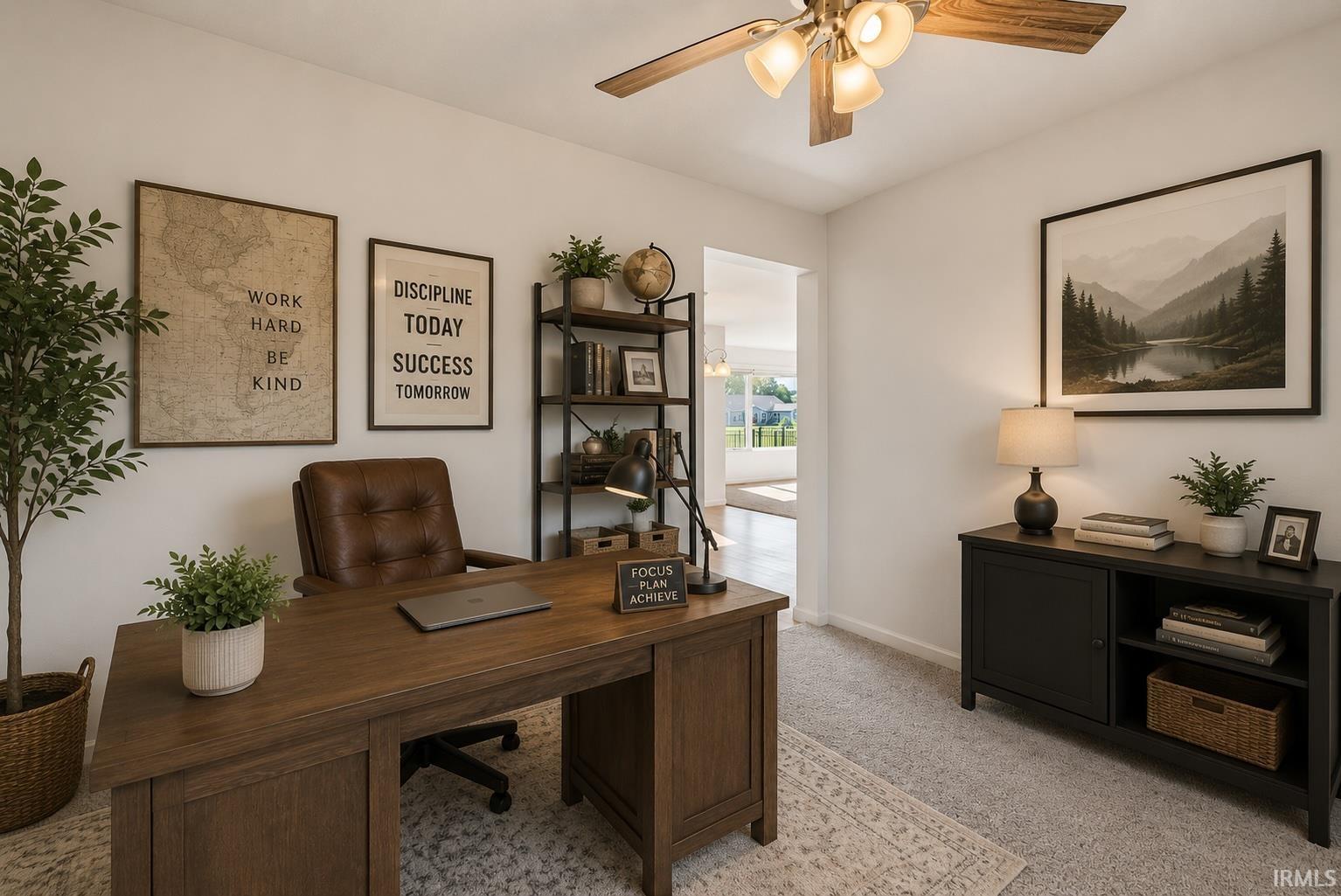 Dedicated space featuring wood-finish flooring, light grey carpeting, and a ceiling fan with light fixture