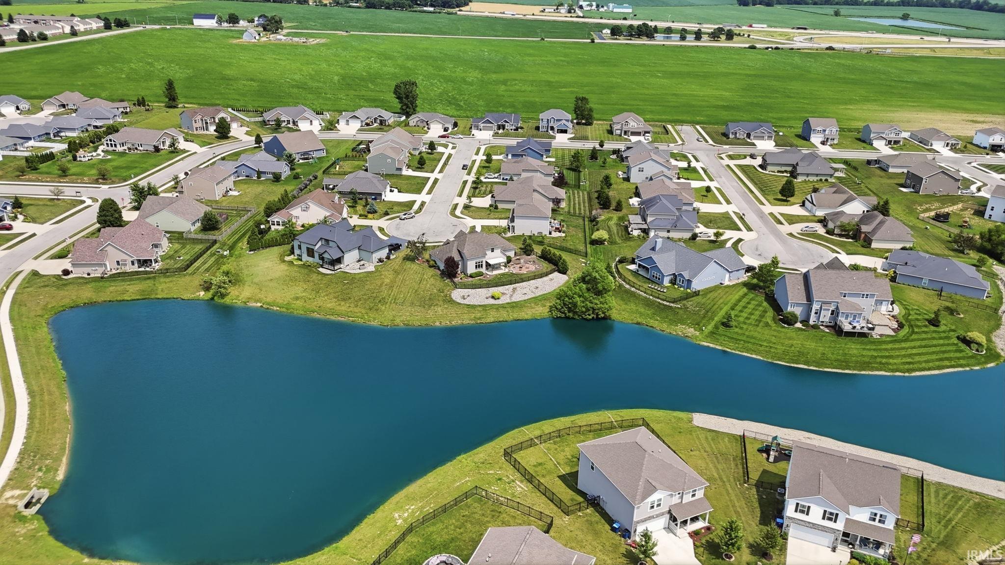 Aerial perspective showcasing a residential community with a central water feature