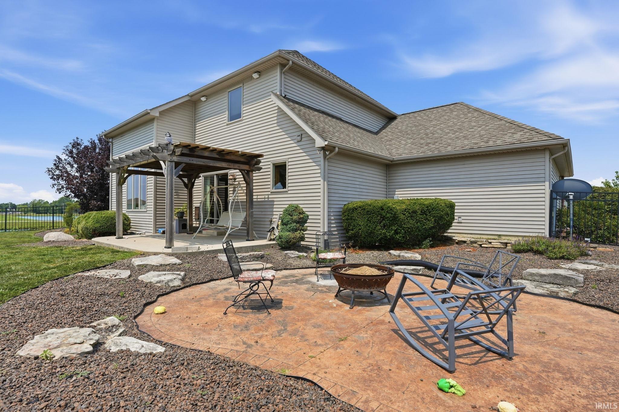 Stamped concrete patio featuring a fire pit
