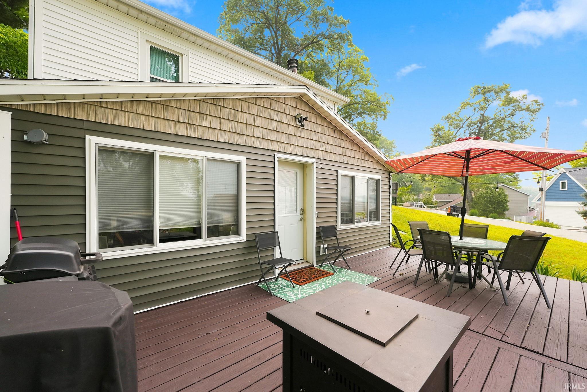 Expansive wood-finish deck with multiple seating areas
