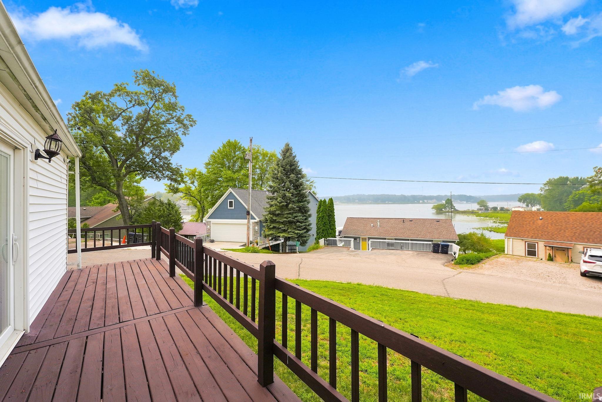 Spacious outdoor deck with dark wood-finish flooring and railing