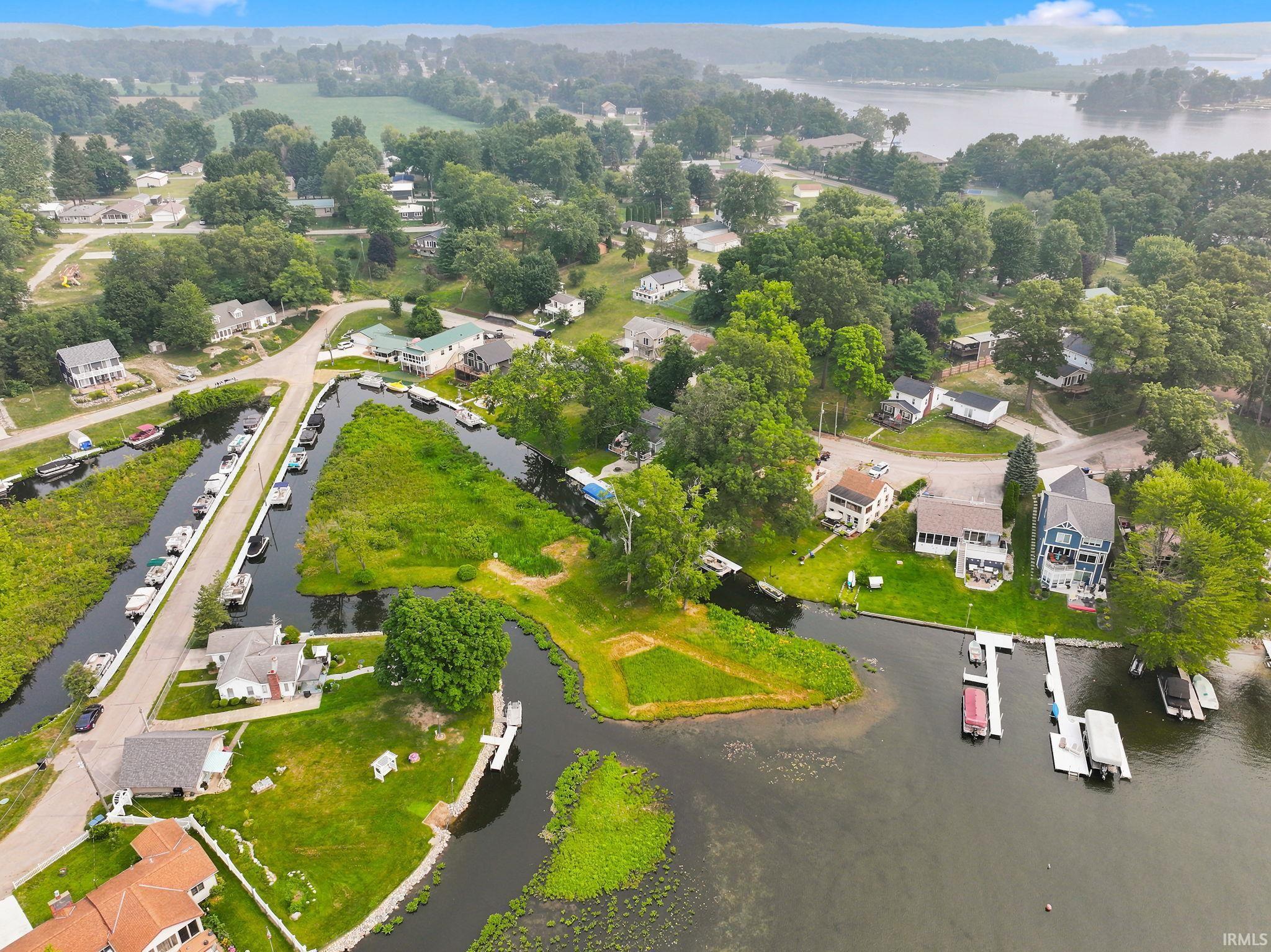 Aerial perspective showcasing a waterfront community with extensive canal access and multiple private boat docks