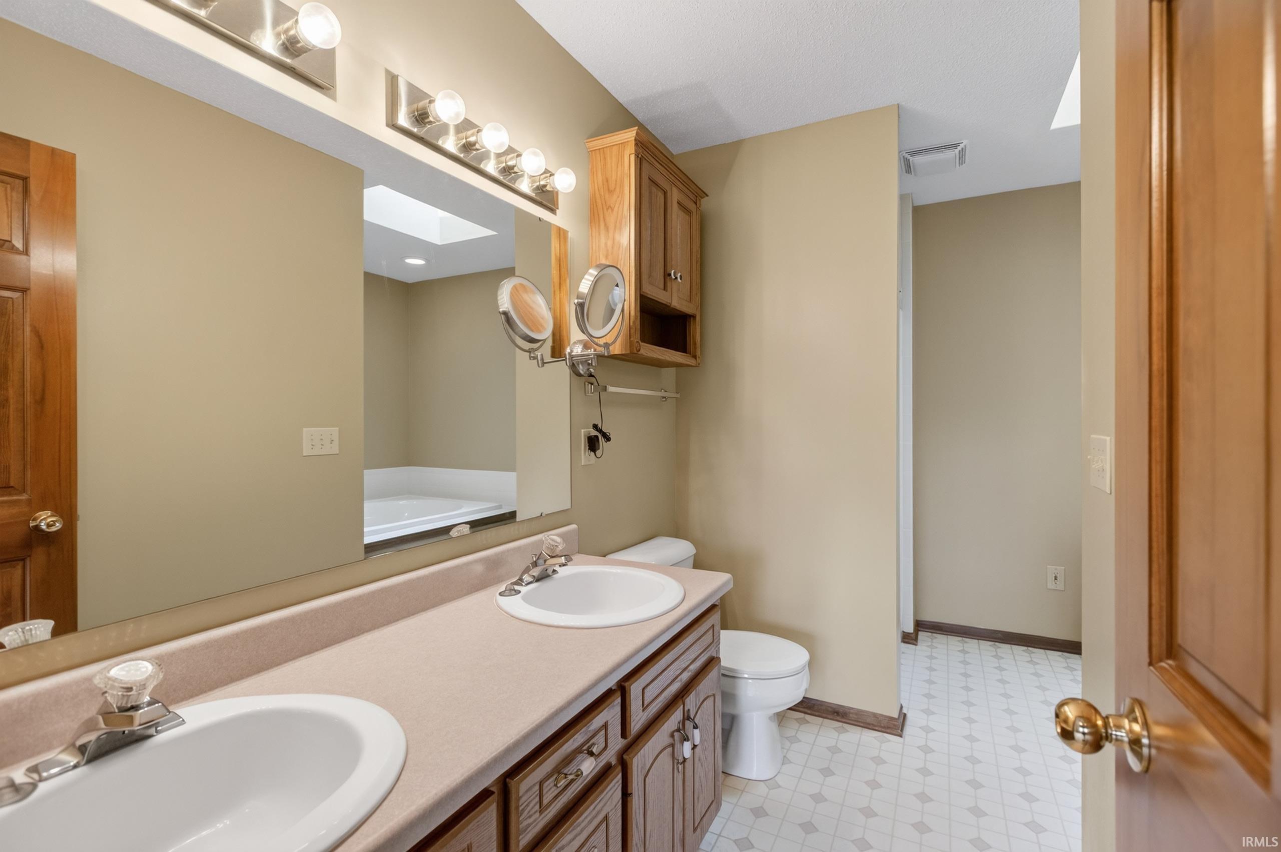 Dual vanity with integrated sinks and a light-toned countertop