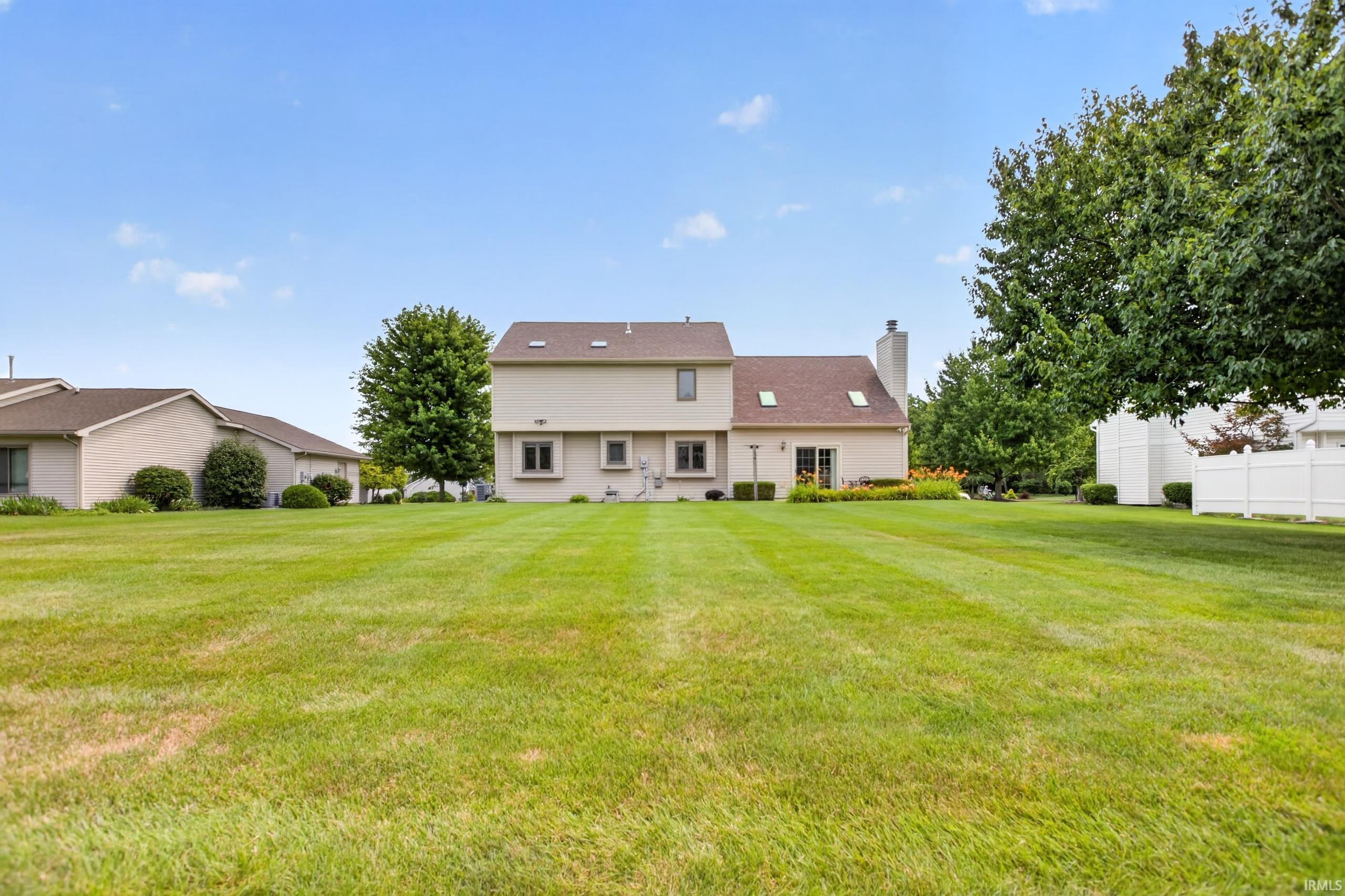 Expansive rear yard featuring a large grass lawn