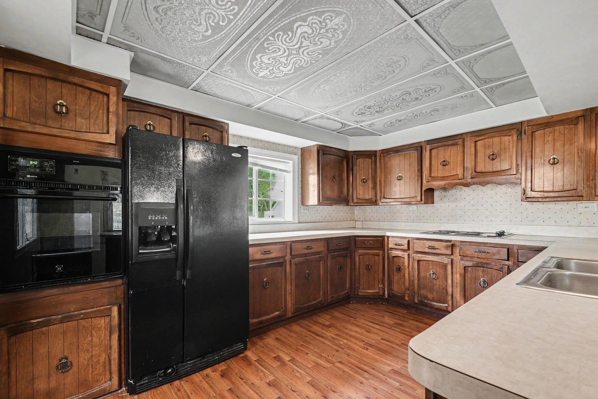 Kitchen featuring wood-finish flooring and extensive wood cabinetry