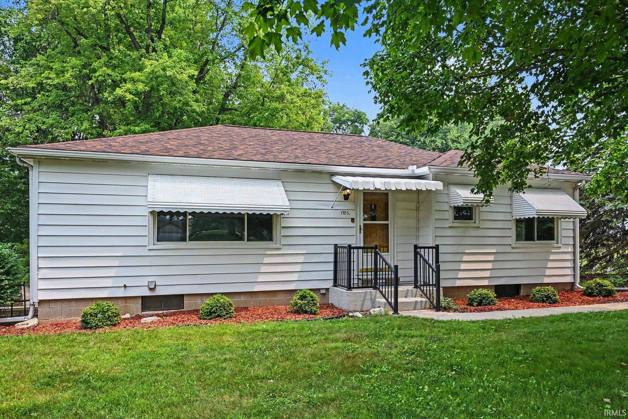 White horizontal siding exterior with a brown shingle roof