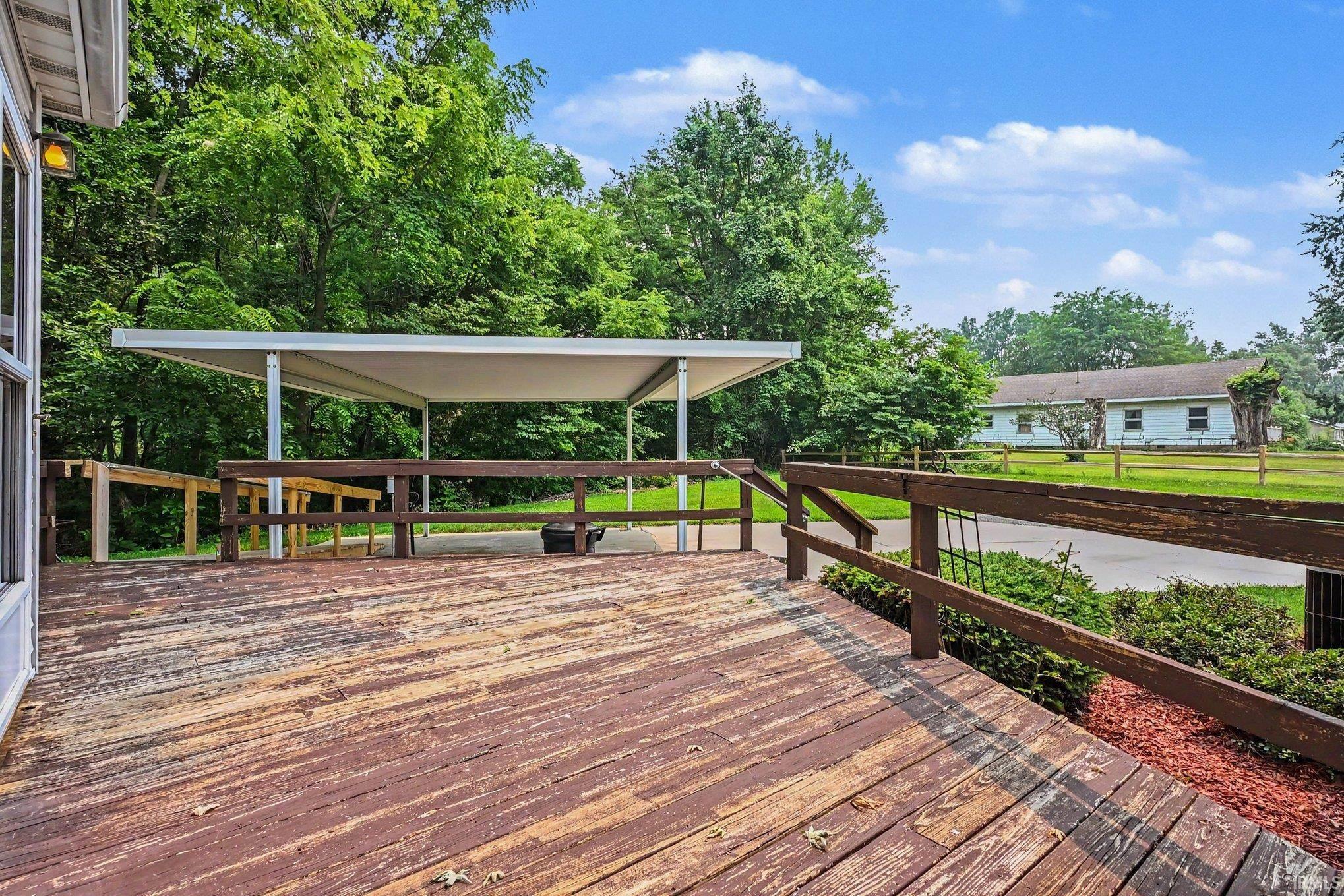 Expansive wood deck with a partial carport structure