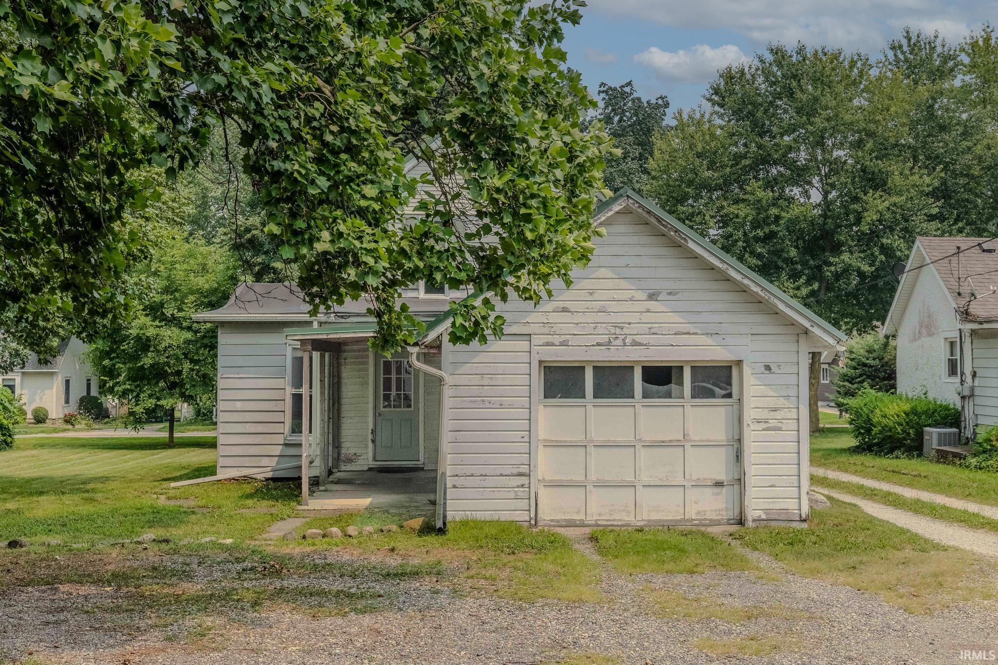 Single-story residence featuring a covered front entry and an attached garage with a panel door