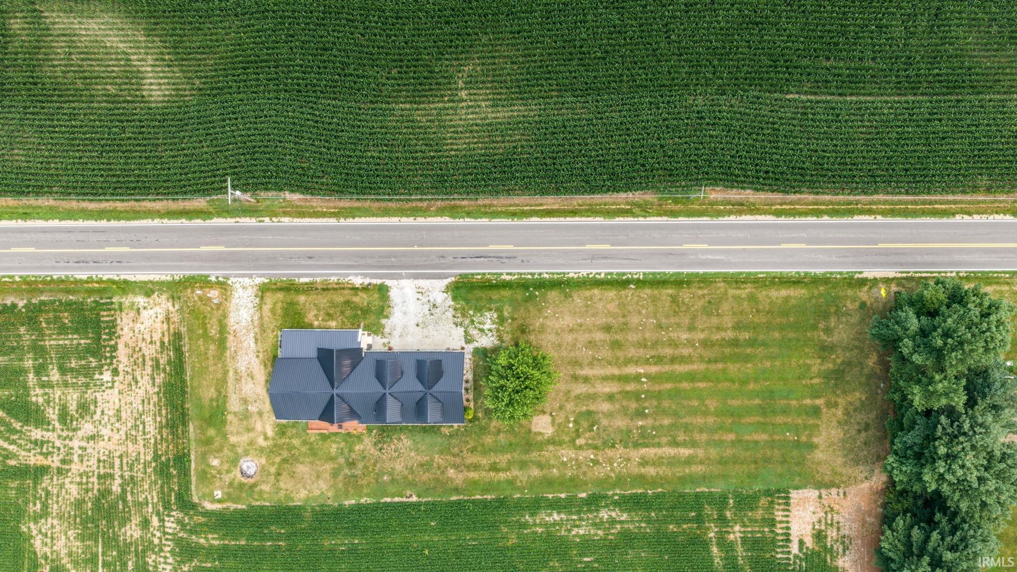 Aerial perspective showcasing a property surrounded by expansive agricultural fields