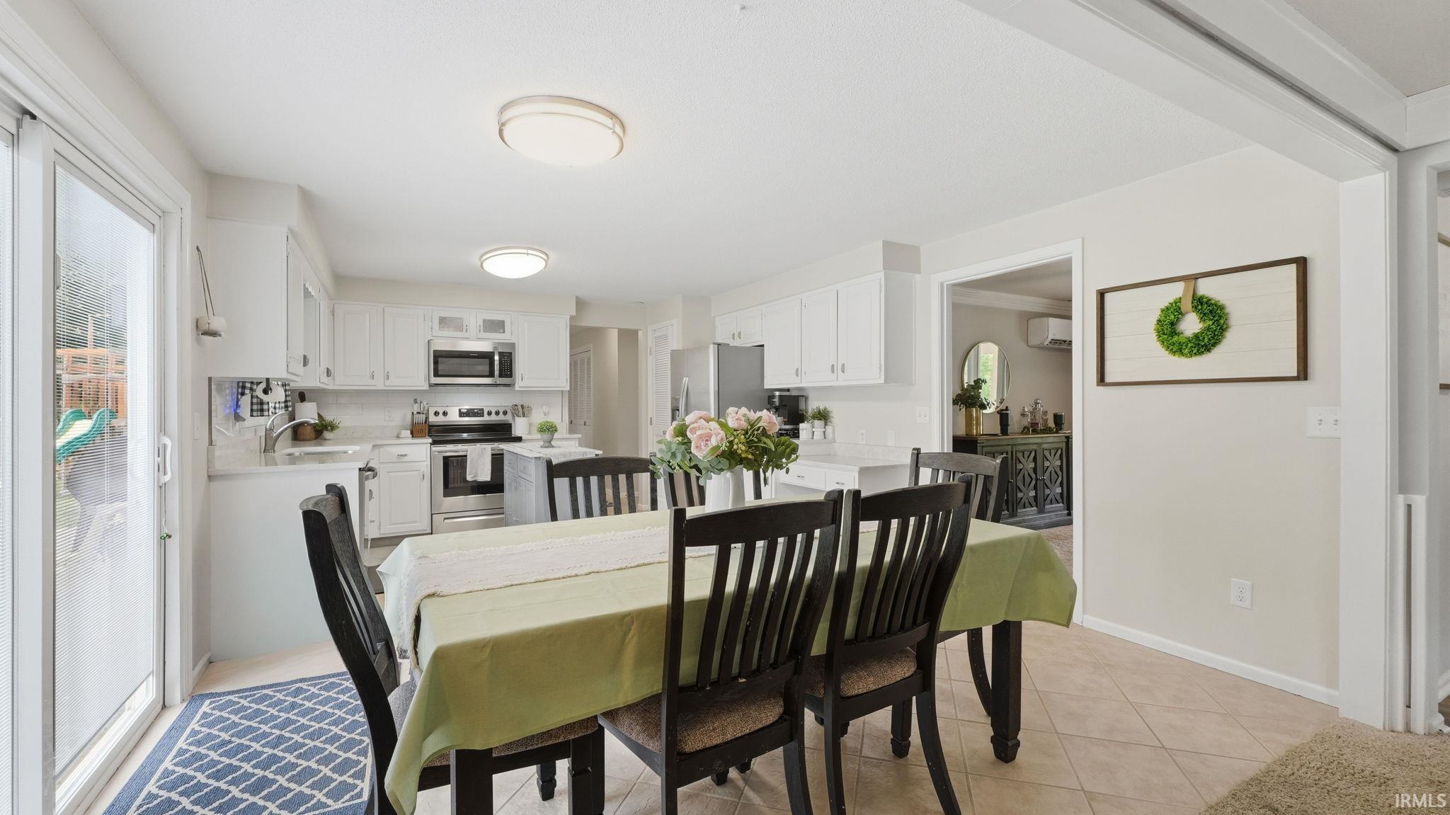 Open-concept dining area with tile flooring and bright overhead lighting