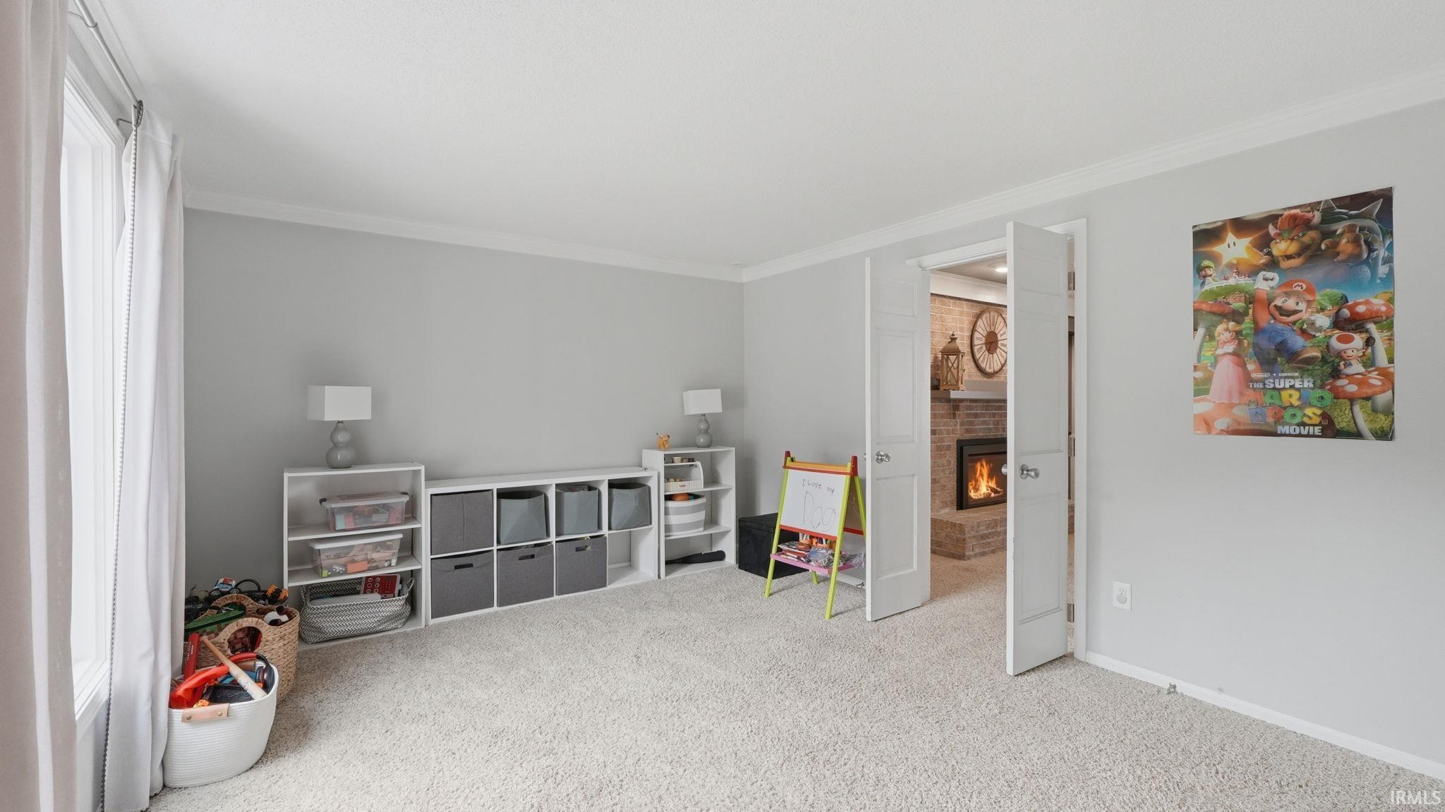 Carpeted room with light gray walls, white trim, and a window featuring white curtains