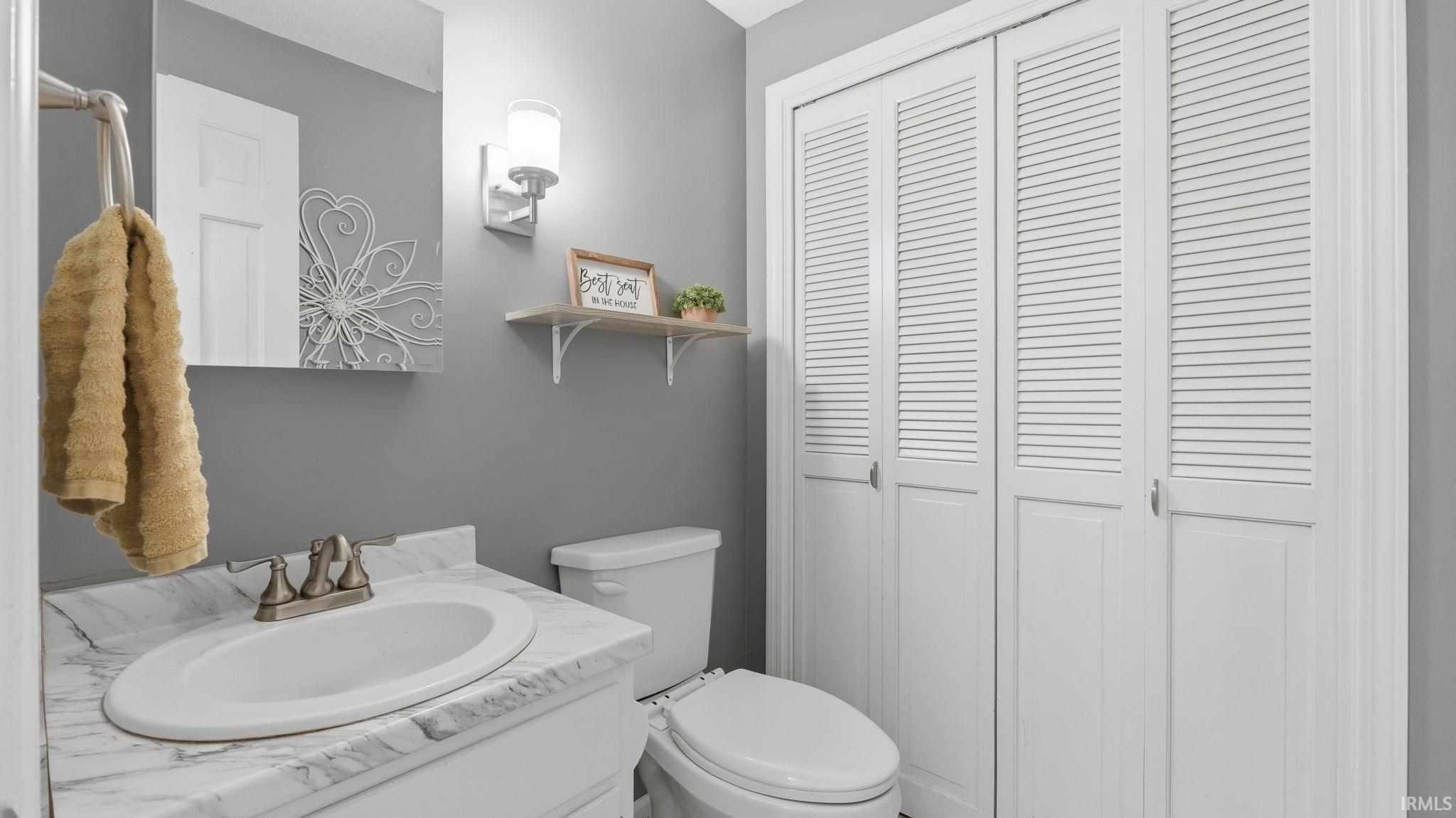 Vanity with an integrated oval sink and a stone-finish countertop