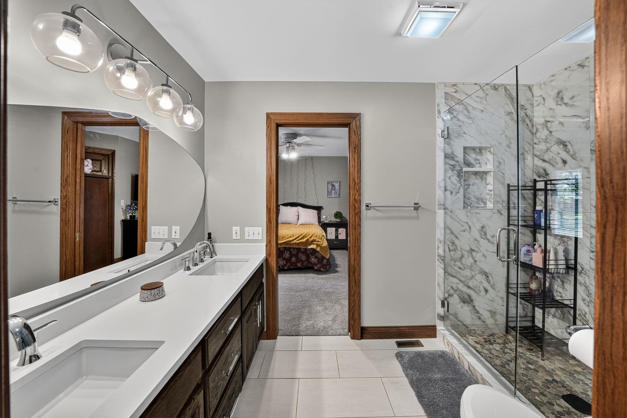 Double vanity with white countertops and undermount sinks