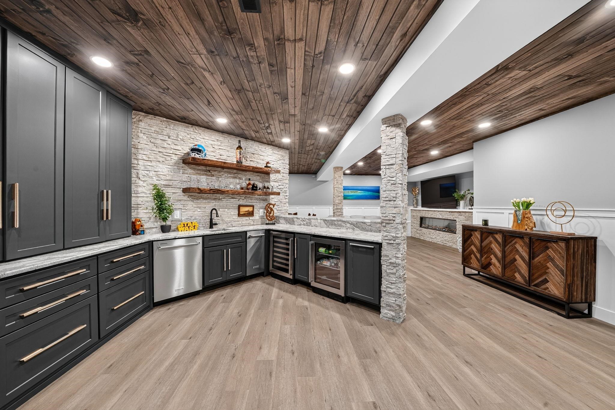 Lower level entertainment area featuring wood-finish flooring, a wood-plank ceiling, and recessed lighting
