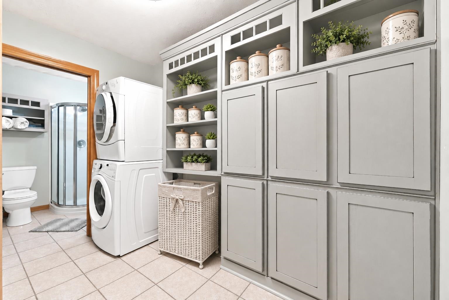 Integrated laundry area featuring stacked appliances