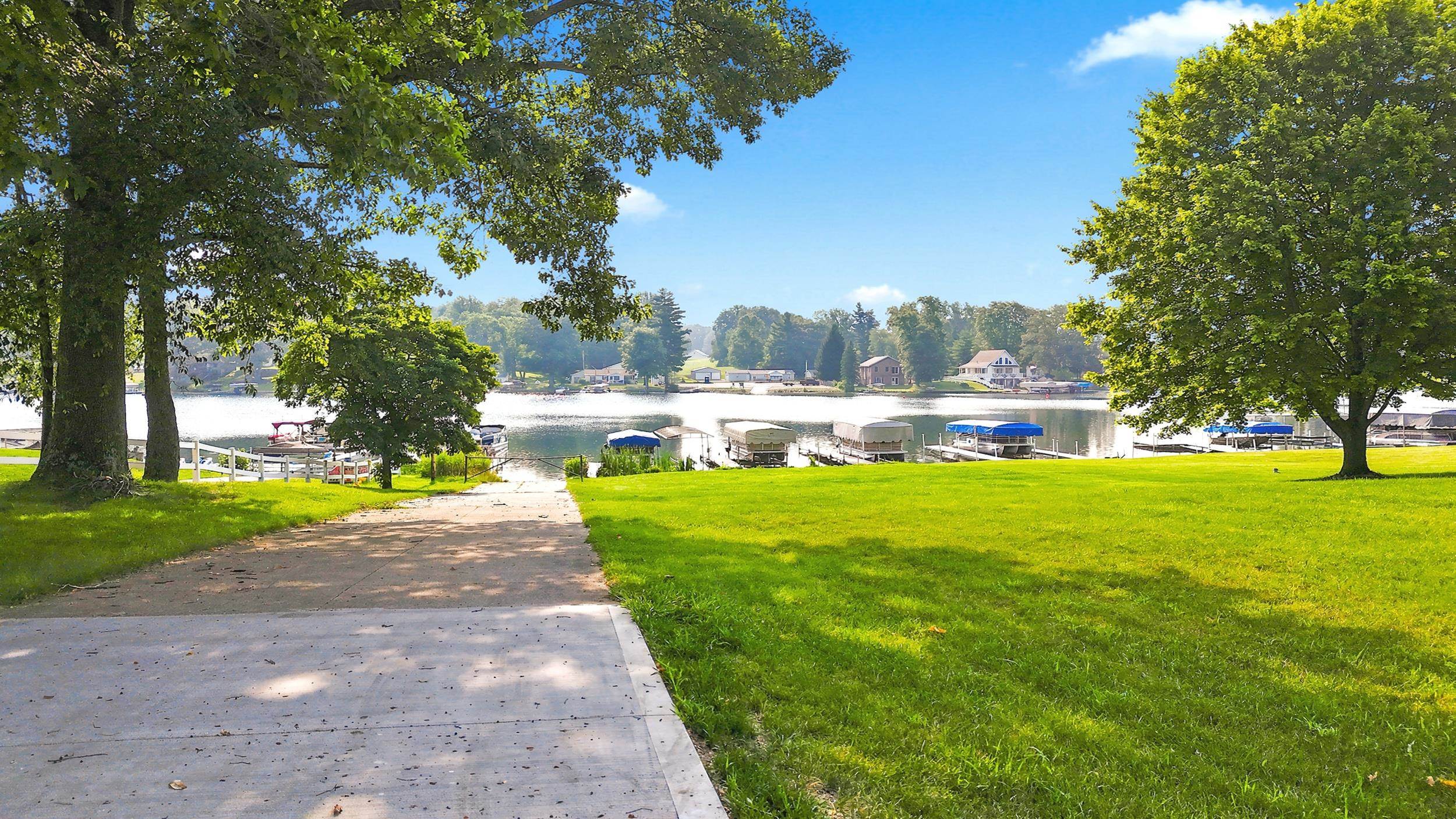 Lakeside property featuring a boat launch and expansive lawn