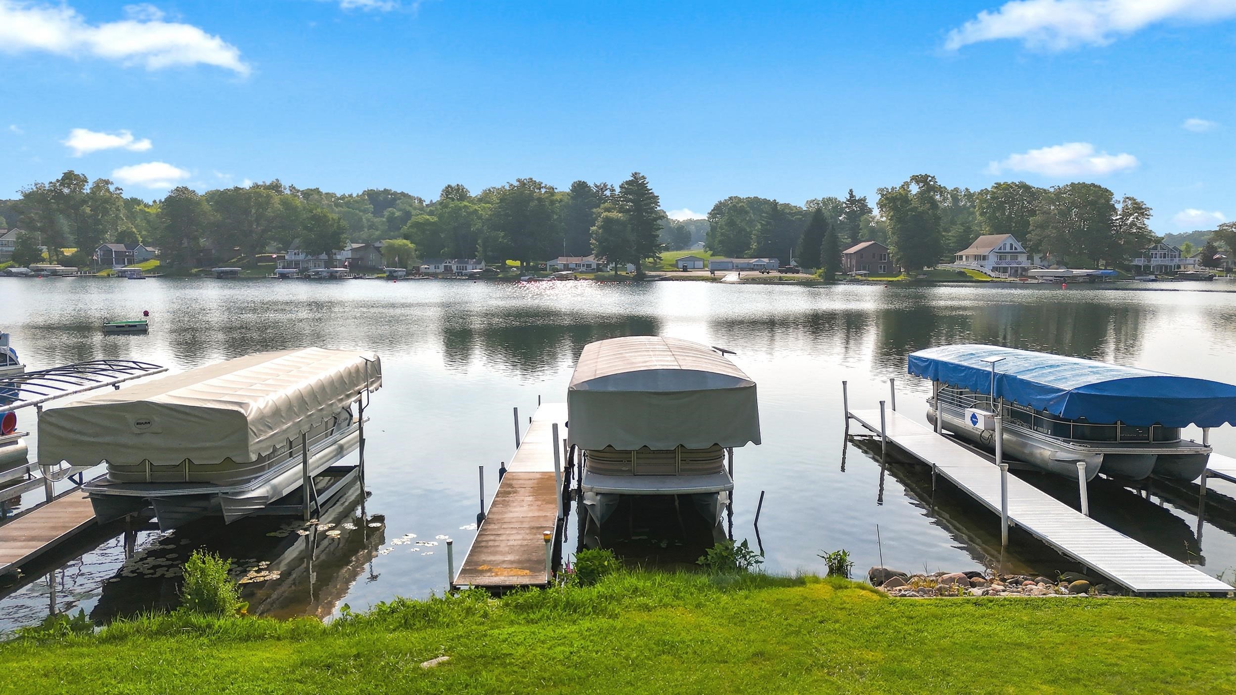 Lakefront property featuring multiple boat docks