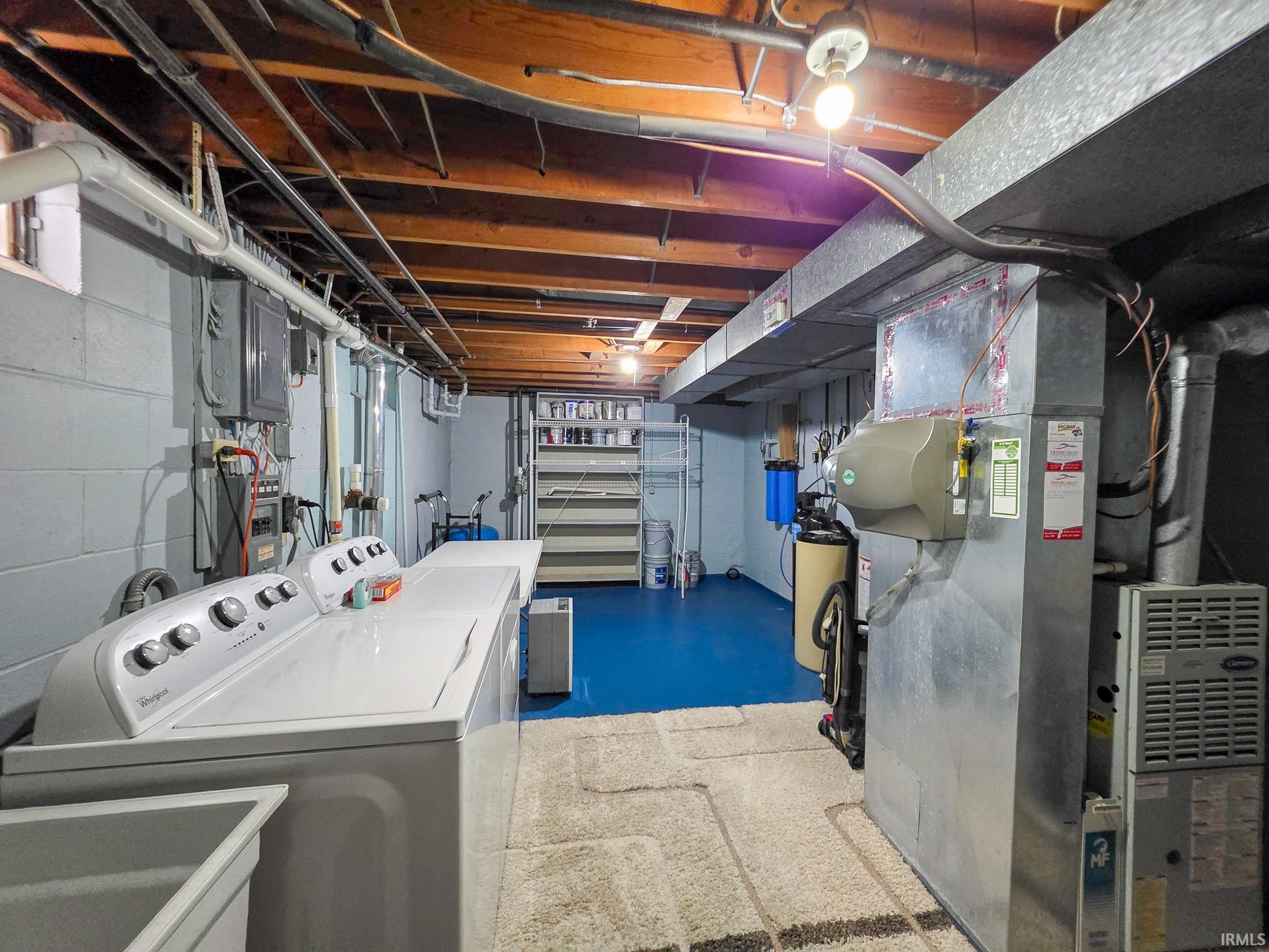 Dedicated laundry area featuring a washer and dryer, utility sink