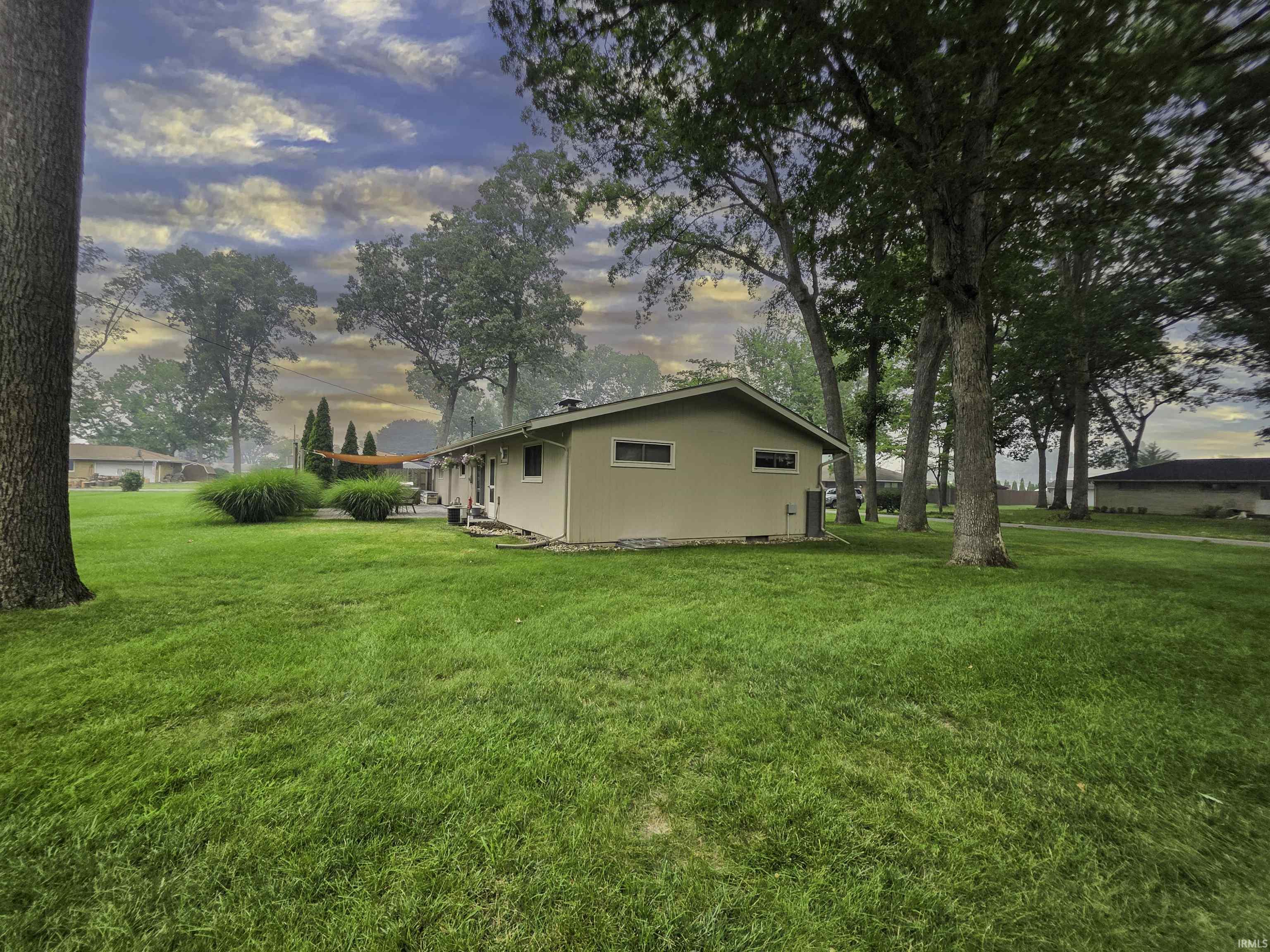 Expansive yard featuring a manicured lawn