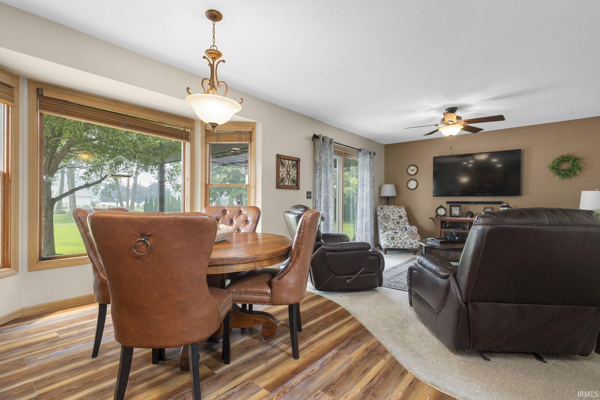 Dining area featuring wood-finish flooring and a bay window