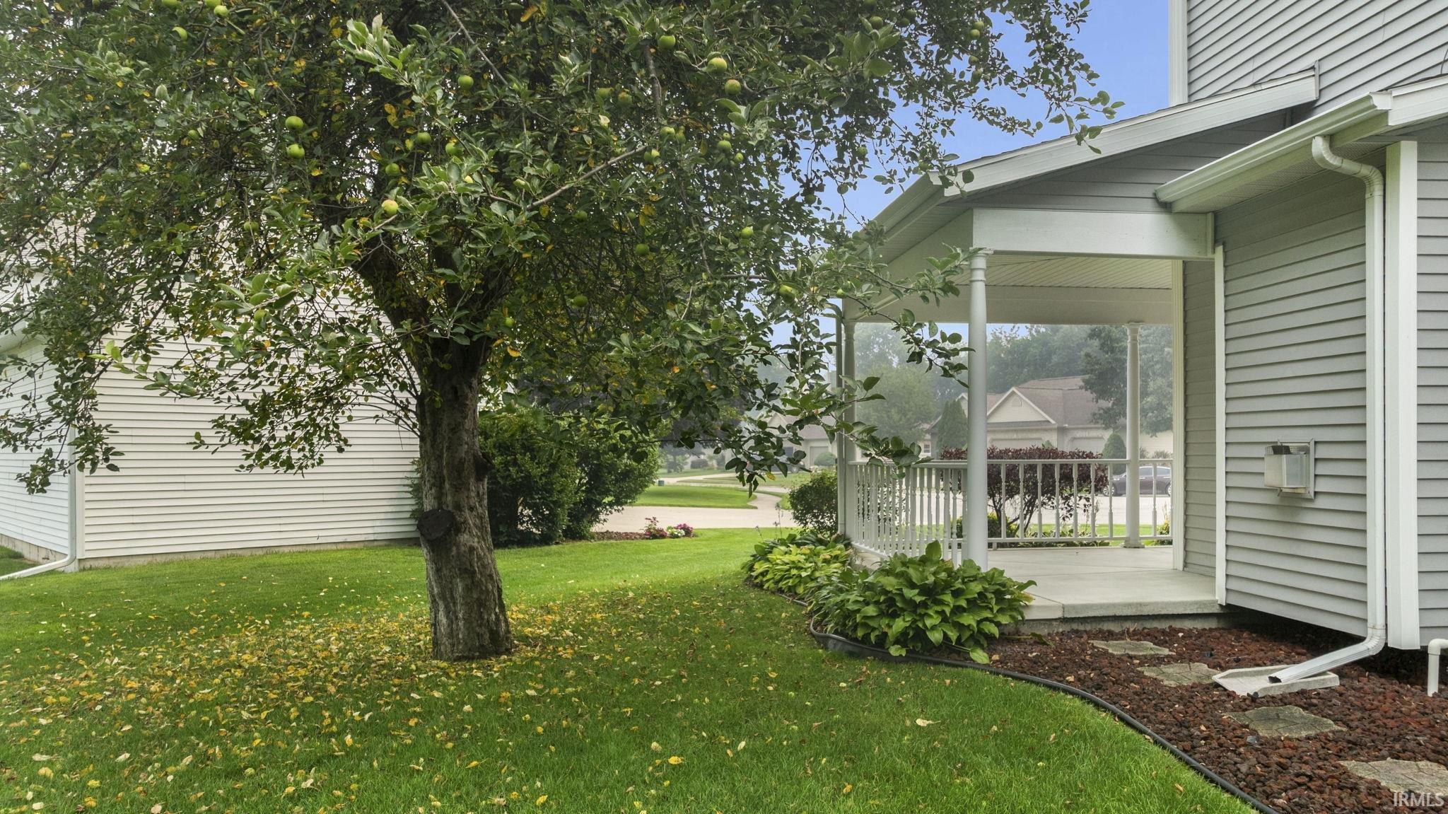 Covered front porch with white railings and columns