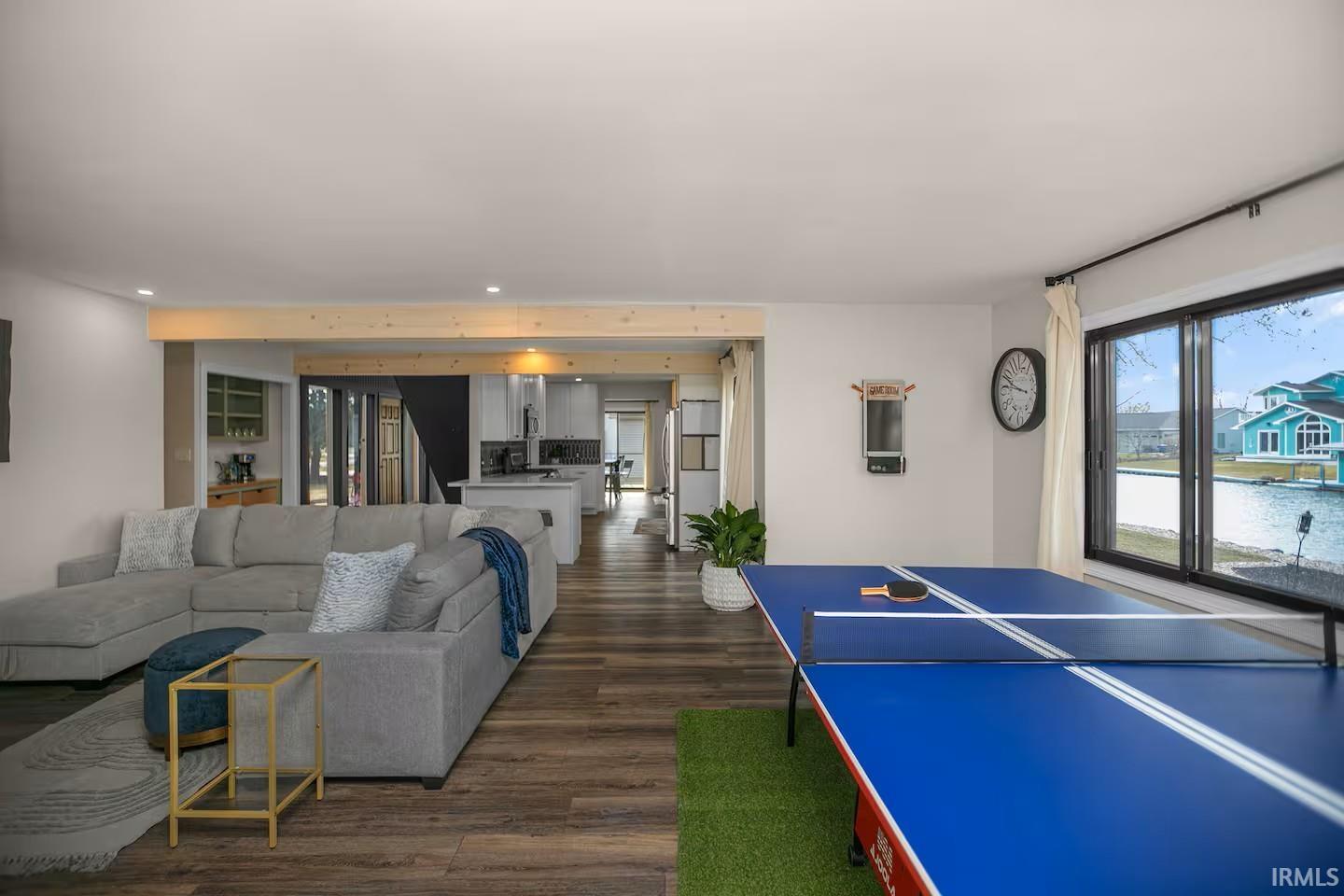 Open-concept living space with wood-finish flooring extending throughout