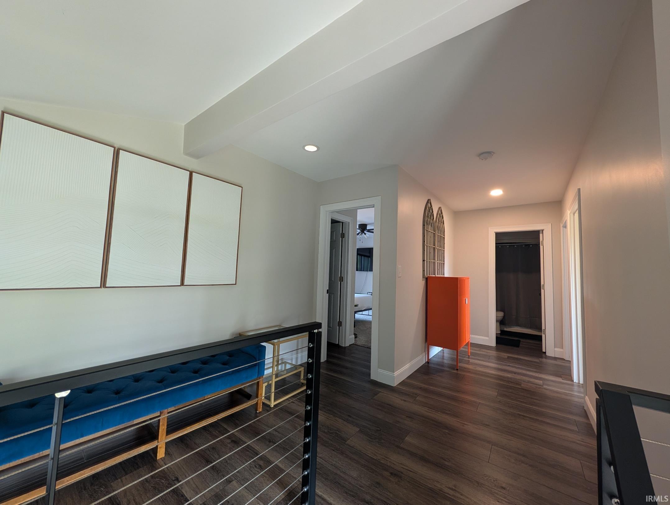 Interior hallway featuring wood-finish flooring, recessed lighting, and a modern cable railing system