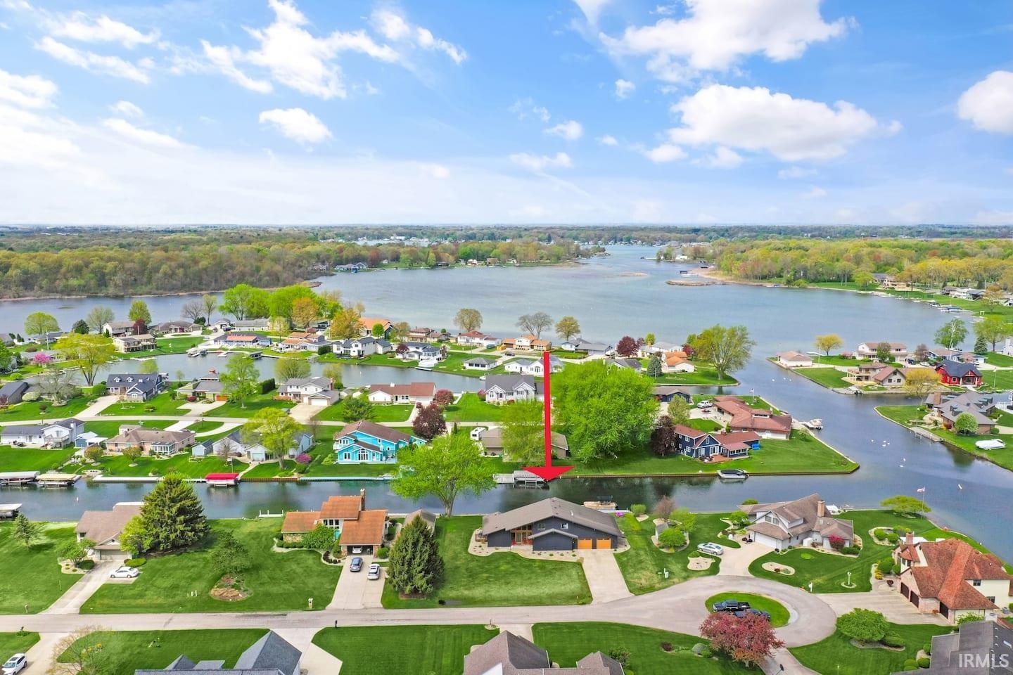 Aerial perspective highlighting the property's waterfront location, featuring direct canal access to the expansive main lake