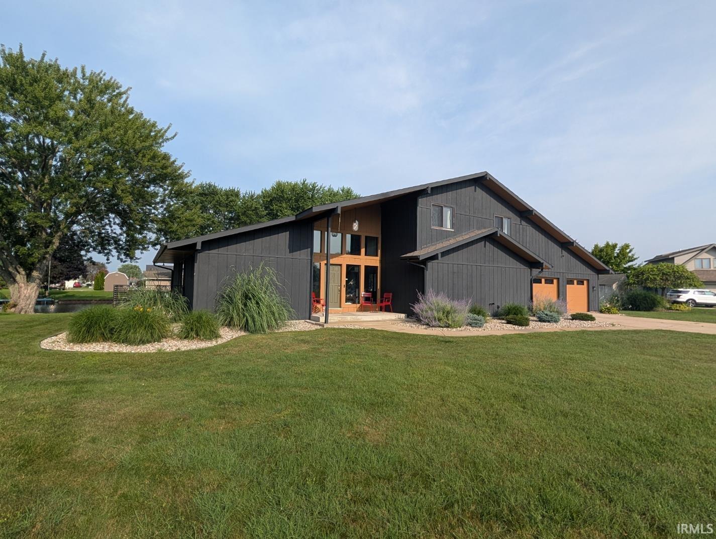 Modern architectural design featuring dark vertical siding and a prominent angled roofline