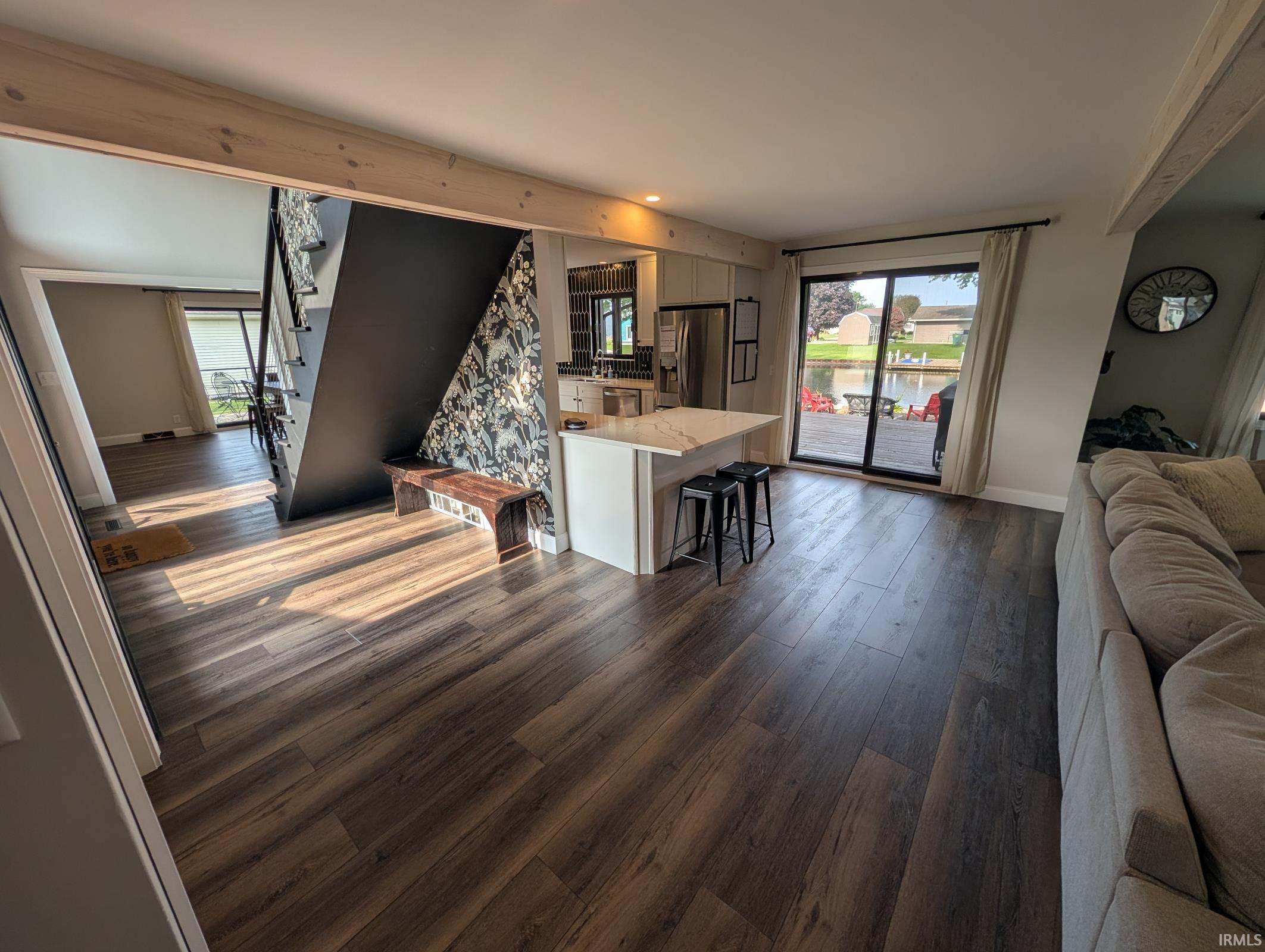 Open-concept living area with wood-finish flooring extending throughout
