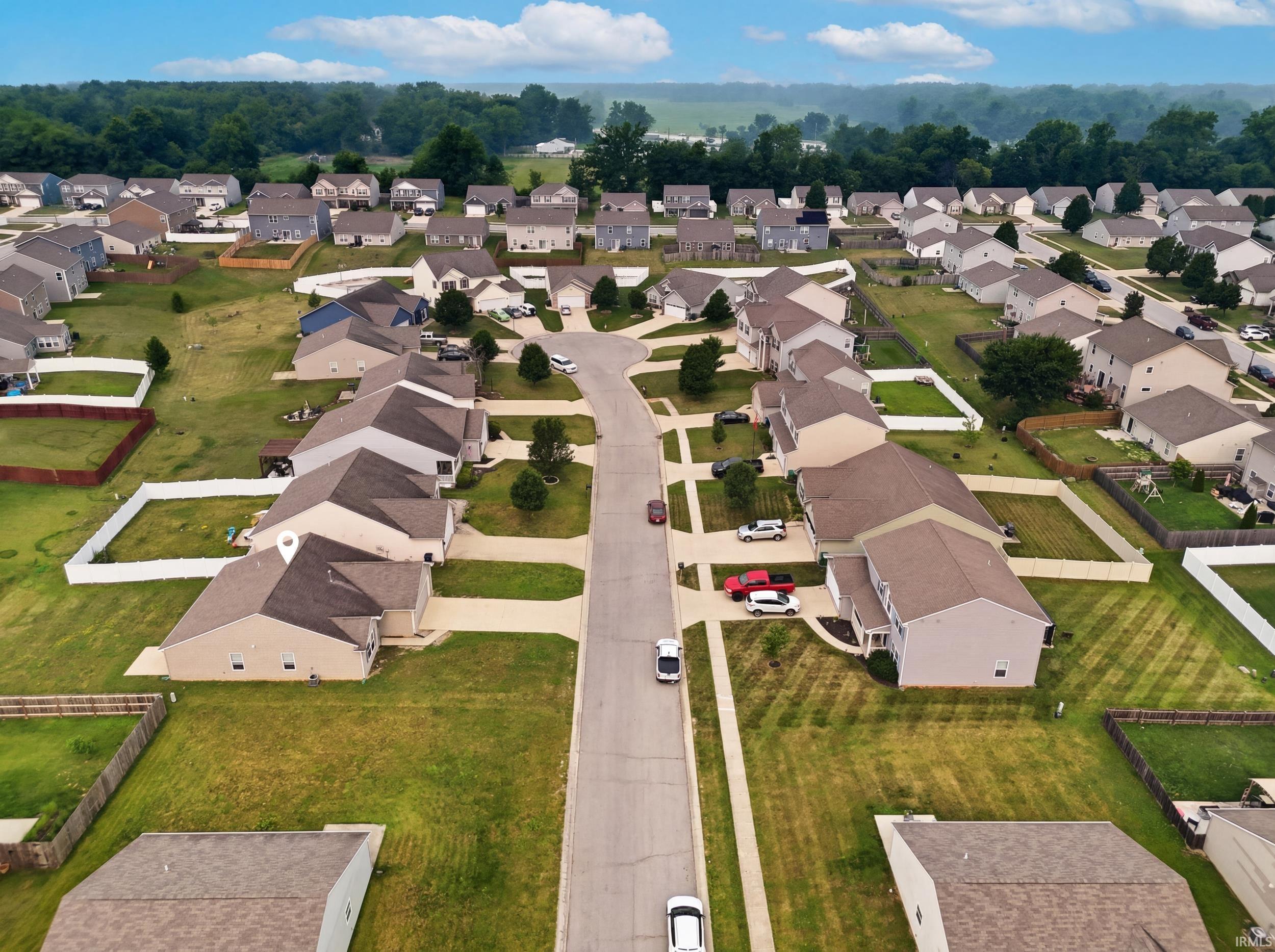 Residential street with single-family homes featuring varied exterior finishes and attached garages