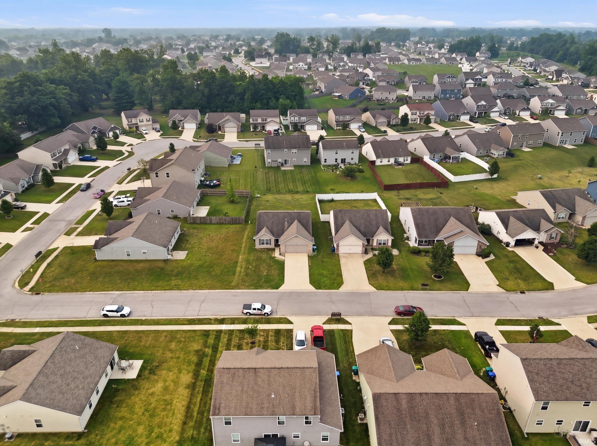 Aerial perspective showcasing a residential community with numerous single-family homes