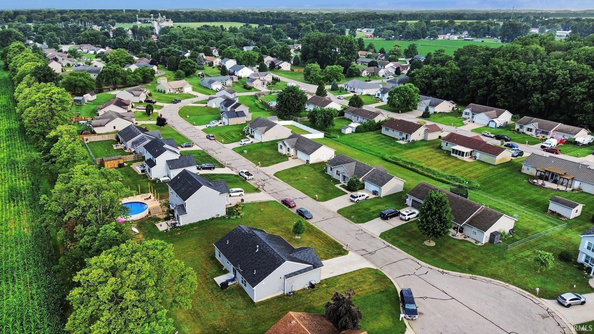 Residential neighborhood featuring a curvilinear street layout and individual single-story properties