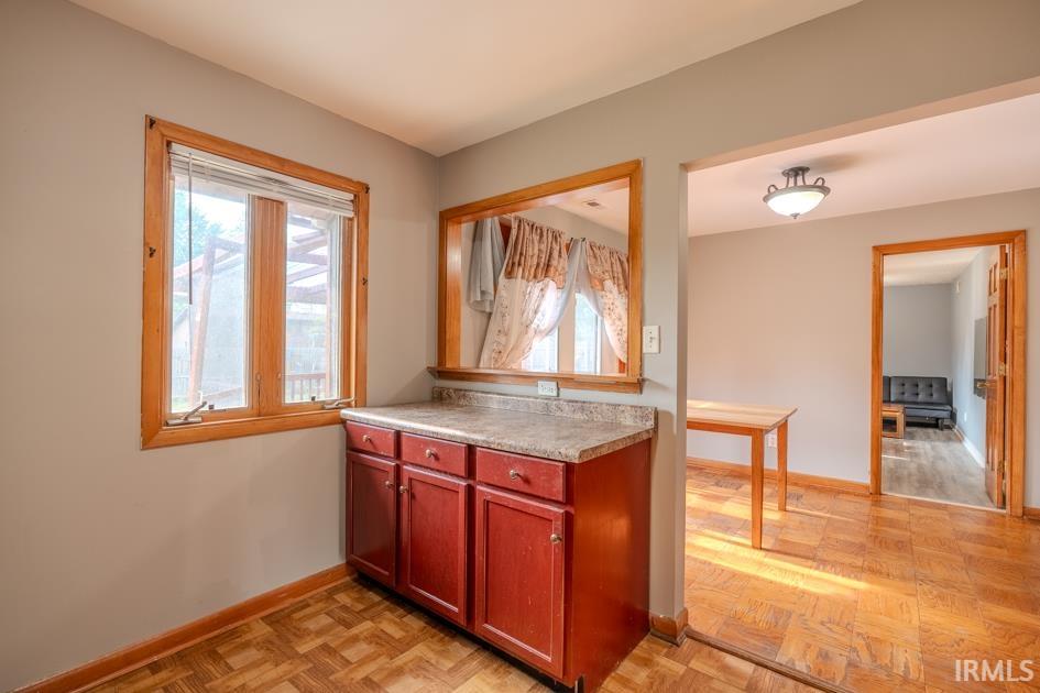 Kitchenette area featuring a built-in base cabinet with a solid surface countertop